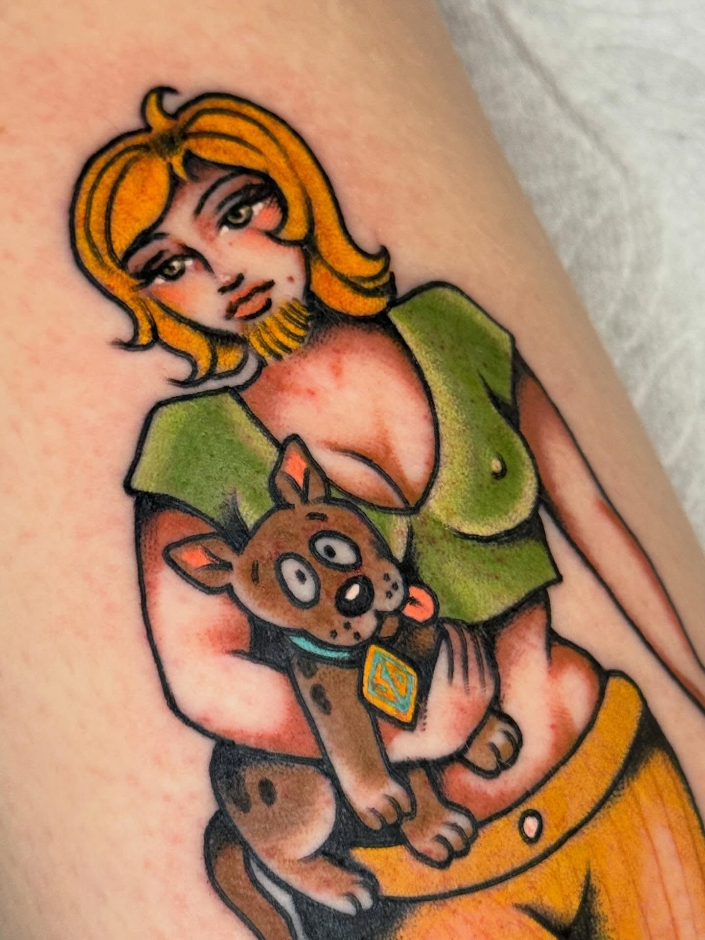 Woman holding dog American traditional tattoo on the thigh by Painted Peach Tattooer
