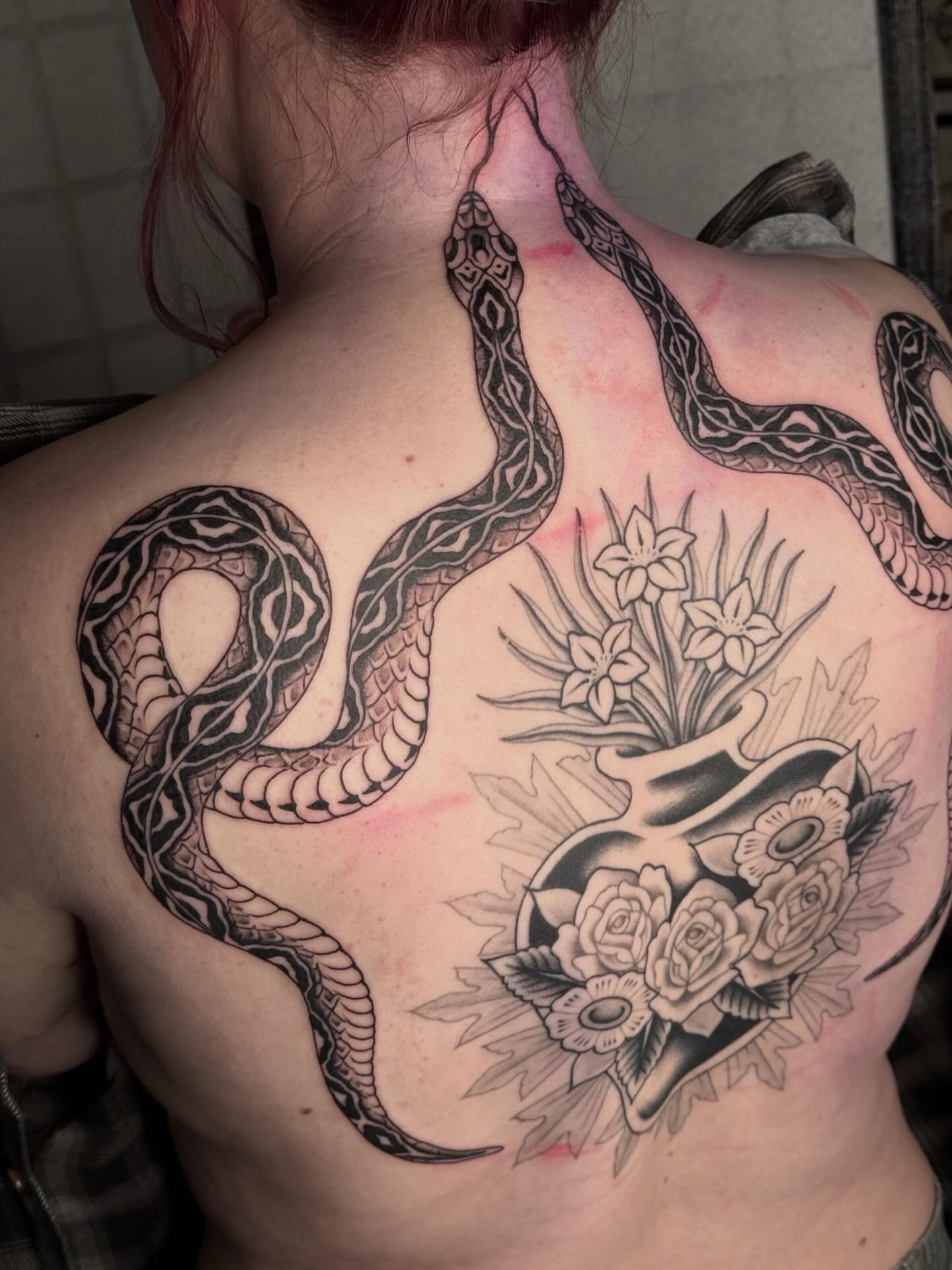 Snake and flowers realism tattoo on the back by Sarah Christine Tattoo, Calgary, Alberta