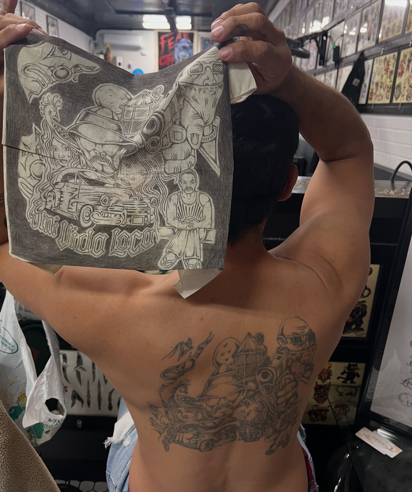 Car and man black and grey tattoo on the back by Nestor Zelaya