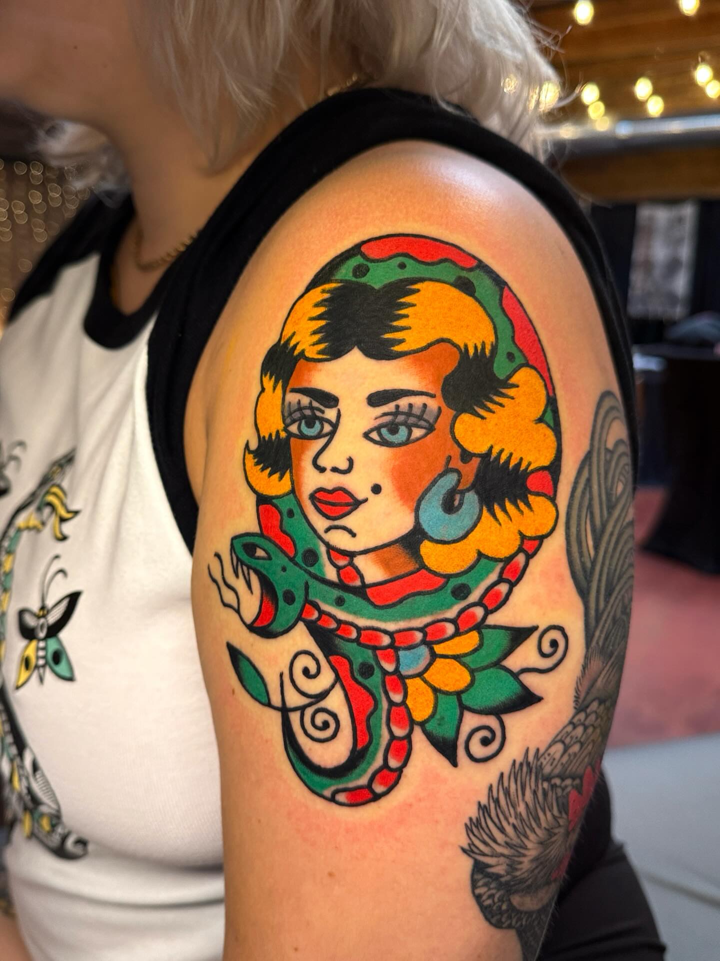 Woman with snake American traditional tattoo on the shoulder by Britt Kuechenmeister, Culver City, California