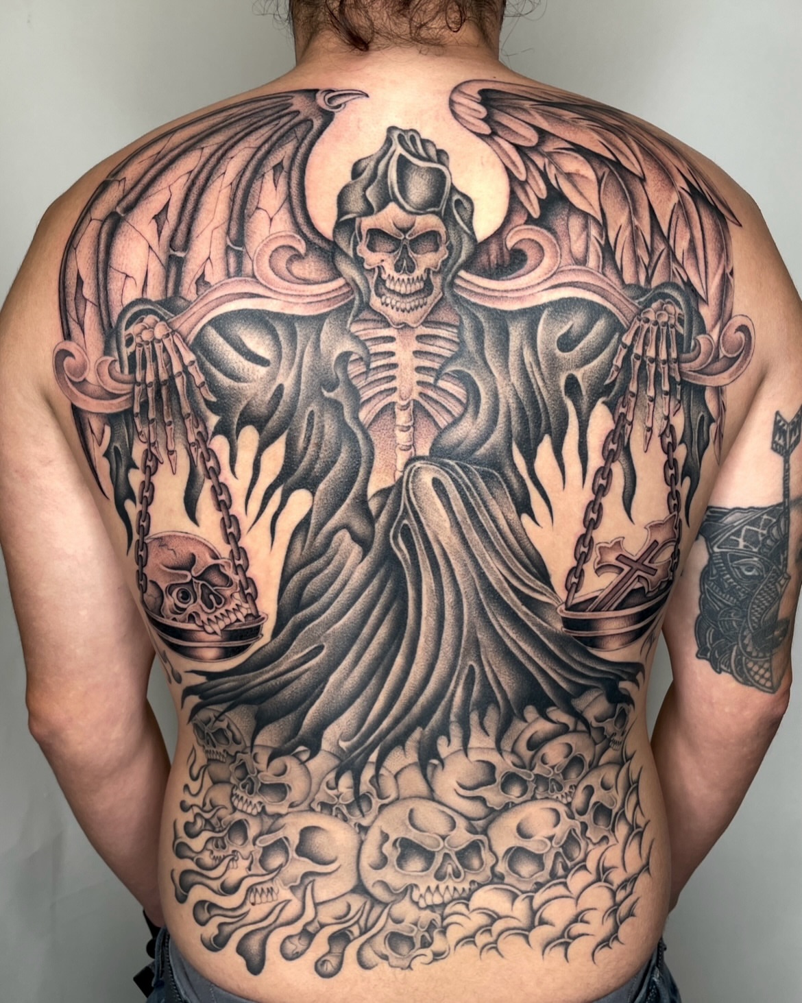 Death figure dark realism tattoo on the back by IVY