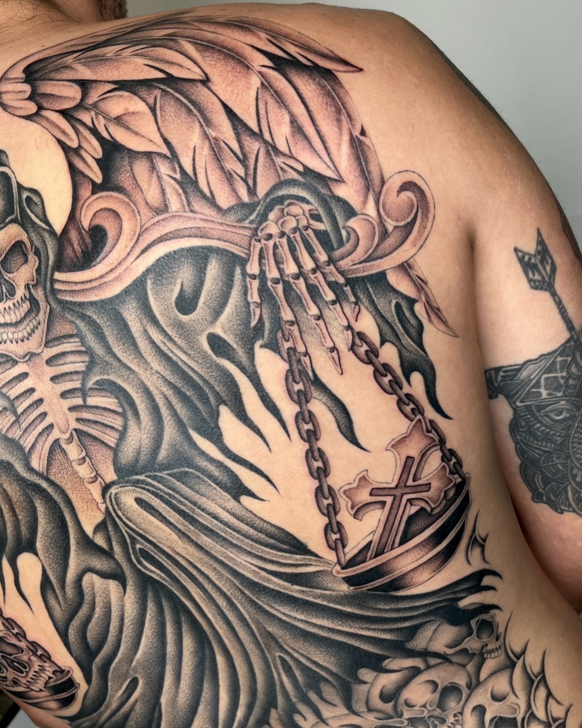 Skeleton and cross American traditional tattoo on the back by IVY