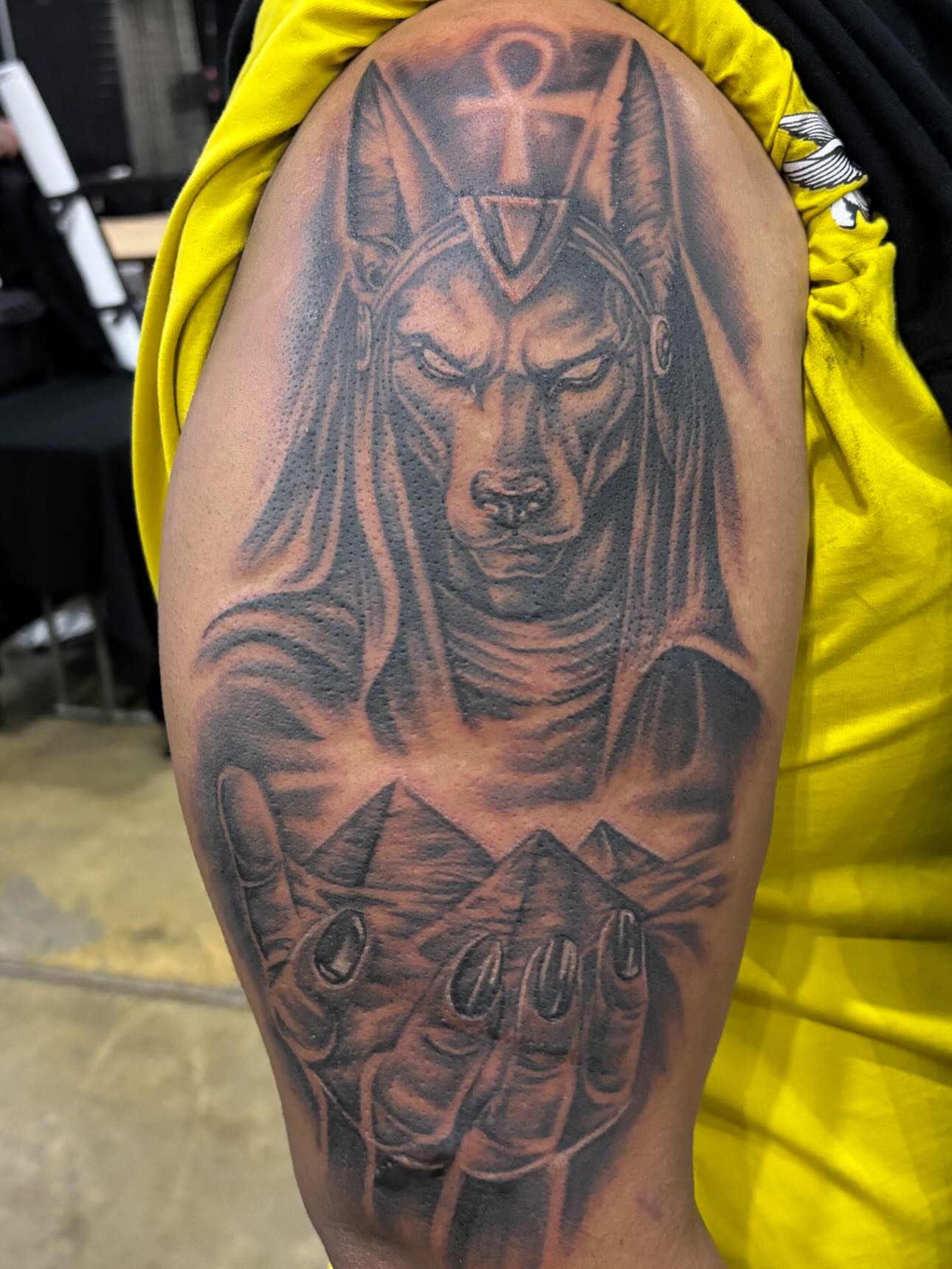 Anubis realism tattoo on the upper arm by Jesus Pubert Munster