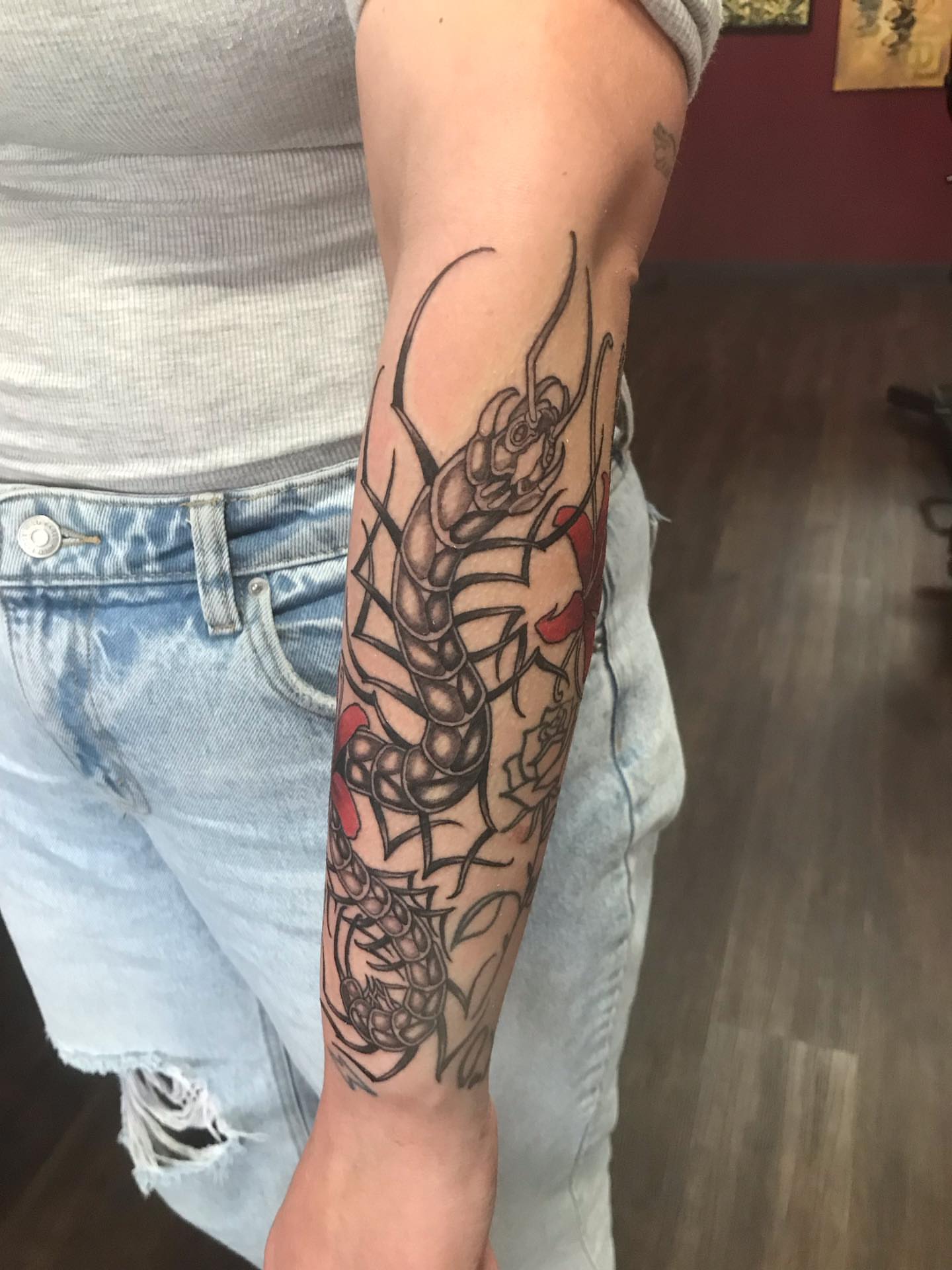 Centipede American traditional tattoo on the forearm by Sean Hollinger