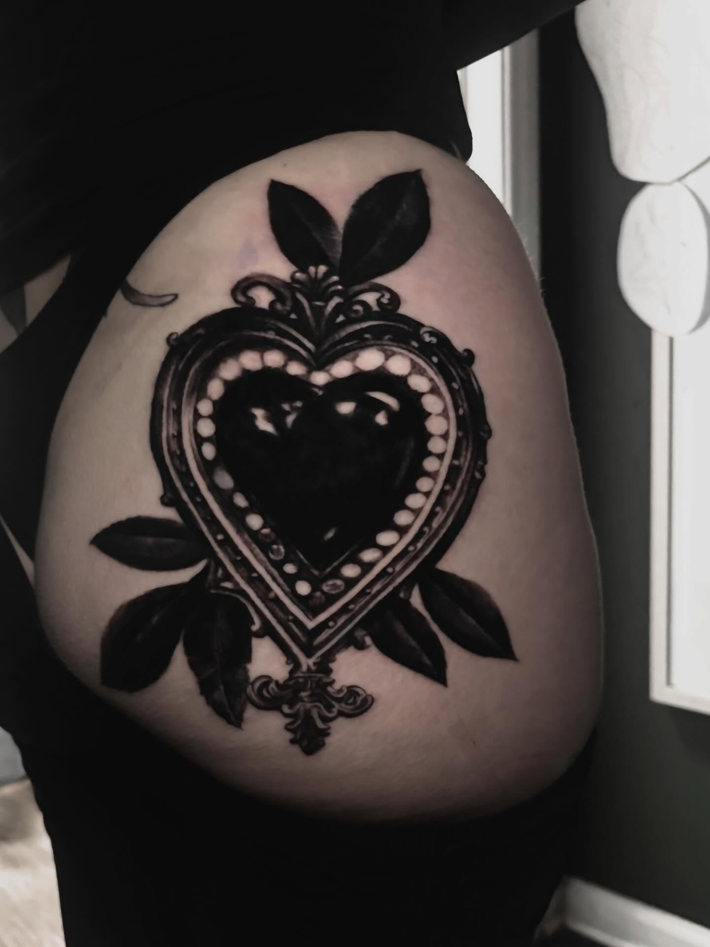 Heart black and grey tattoo on the torso by Alle