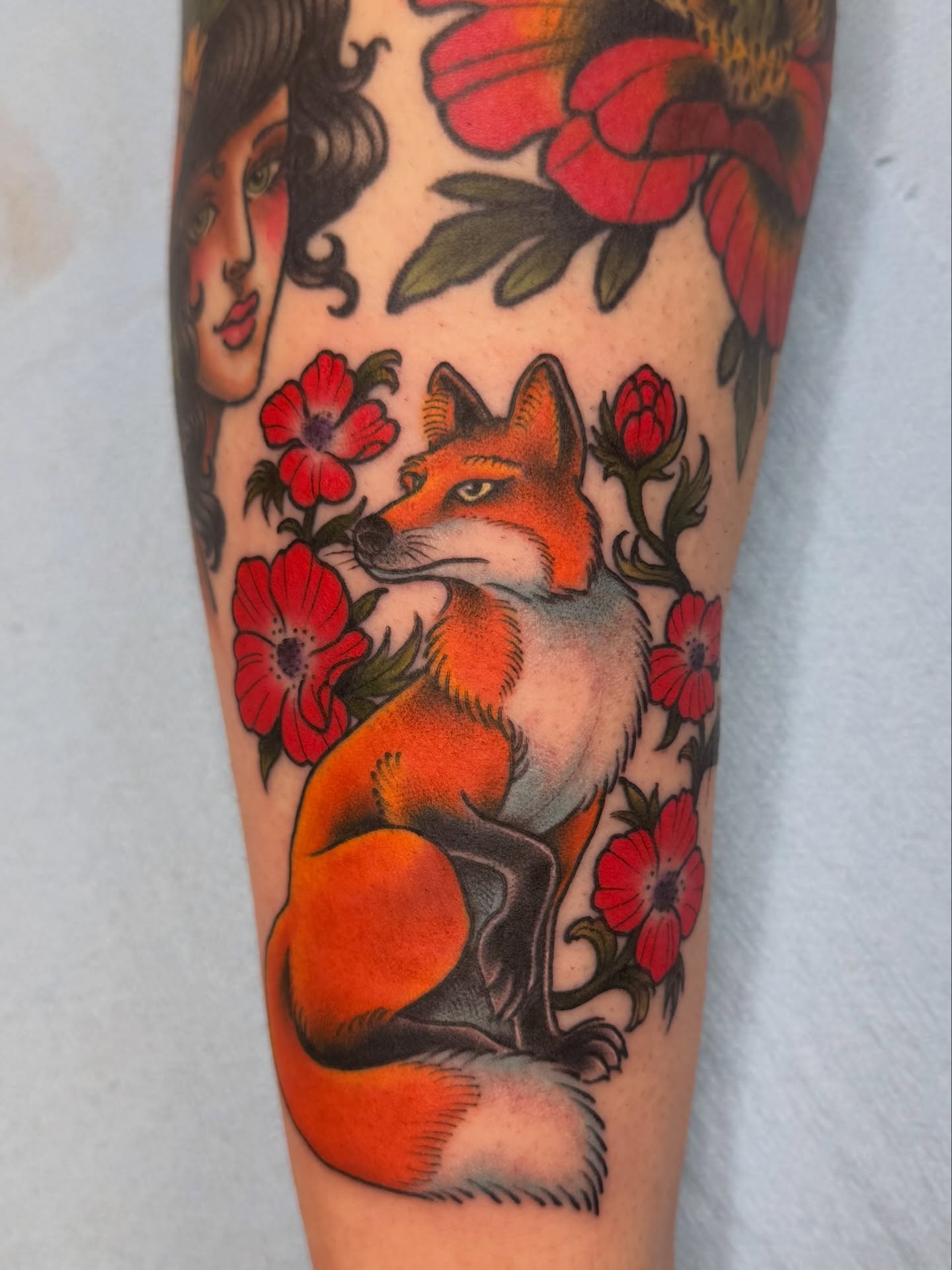Fox and flowers American traditional tattoo on the forearm by Anna Wall