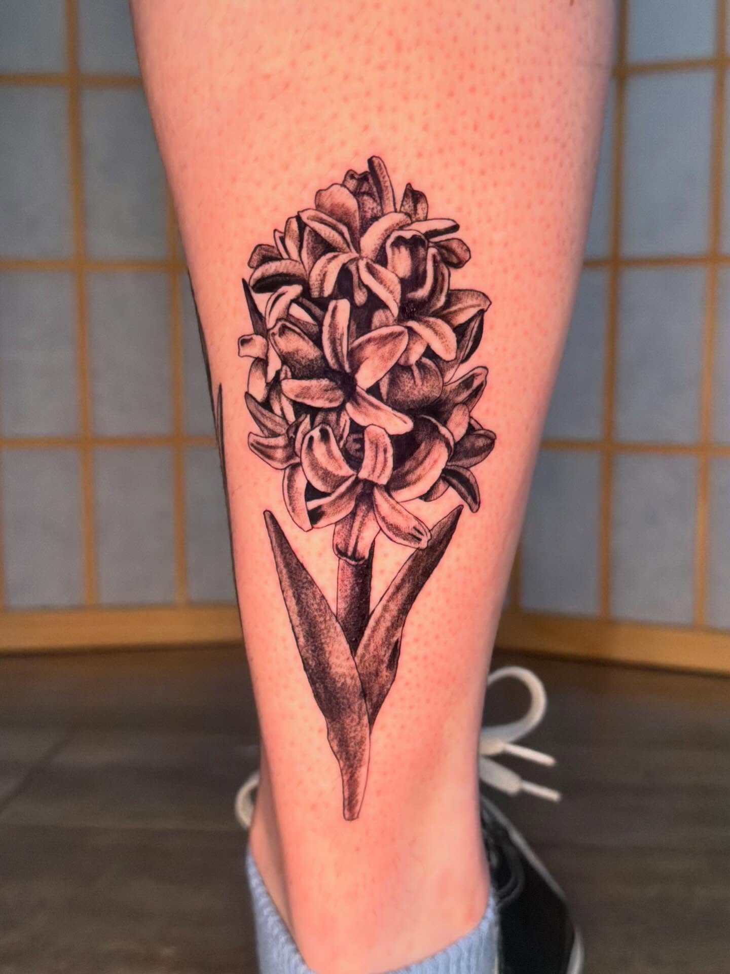 Hyacinth dotwork tattoo on the calf by hallow ☣︎ tattoo artist, Philadelphia, Pennsylvania