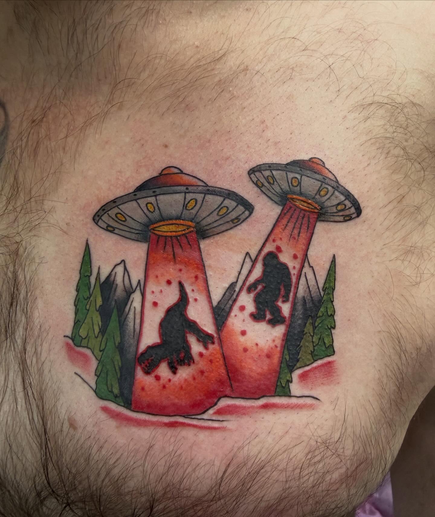 Aliens abducting Bigfoot trash polka tattoo on the chest by Tina Gregg, North Ridgeville, Ohio