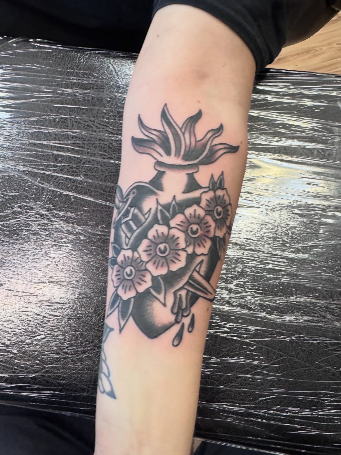 Flower bouquet black and grey tattoo on the forearm by Justin Chapman, Des Moines, Iowa