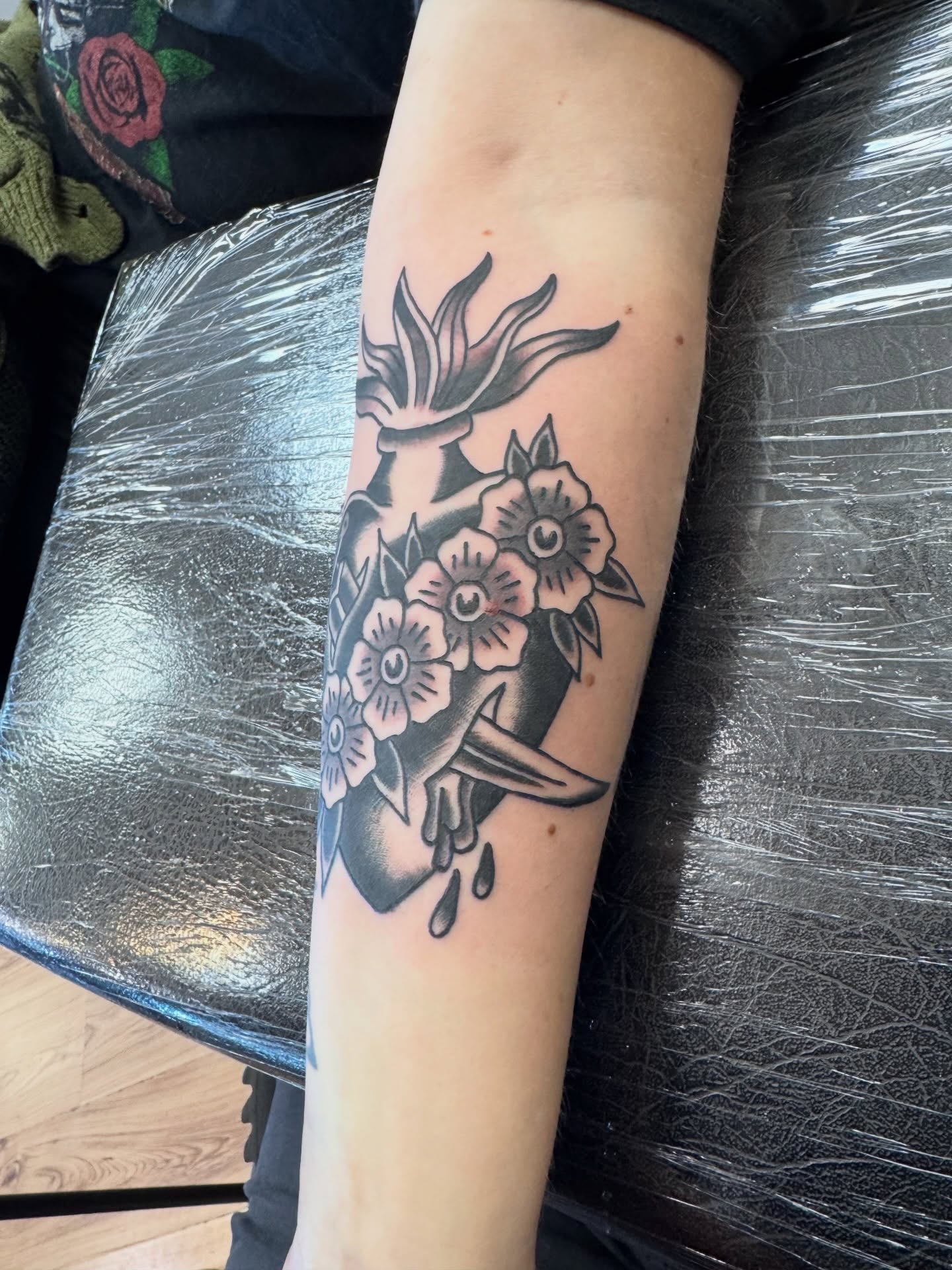 Flower bouquet black and grey tattoo on the forearm by Justin Chapman, Des Moines, Iowa