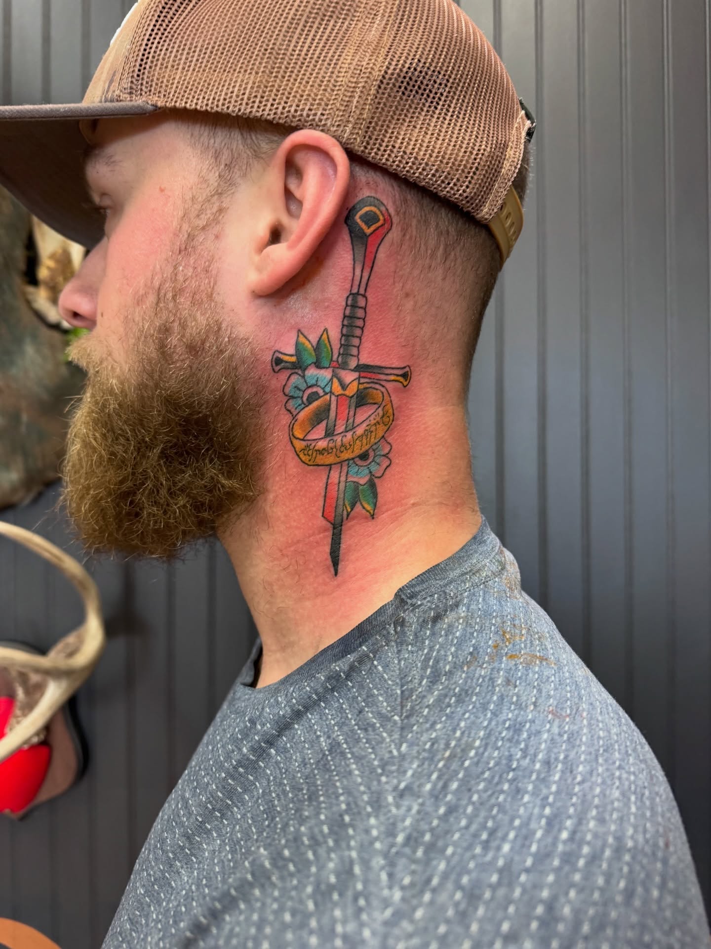 Sword and ribbon American traditional tattoo on the neck by Justin Chapman, Des Moines, Iowa