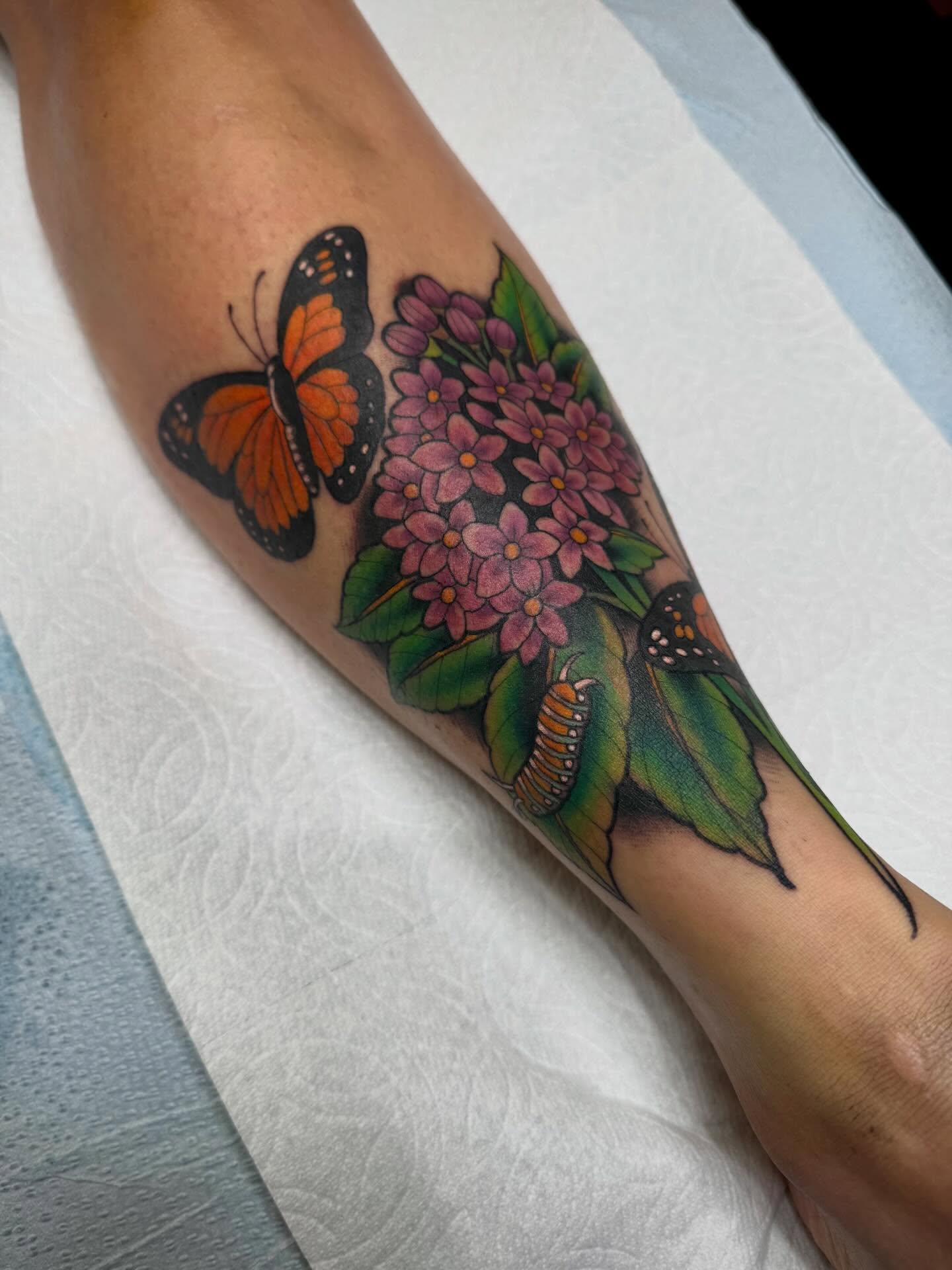 Butterfly and flowers new school tattoo on the forearm by Tyler Harrington