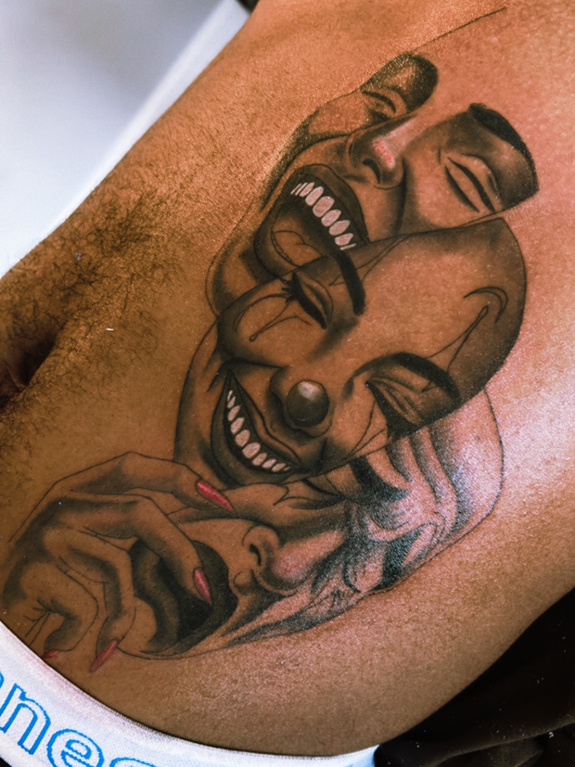 Clown American traditional tattoo on the upper arm by Tito Cross ❤️‍🔥