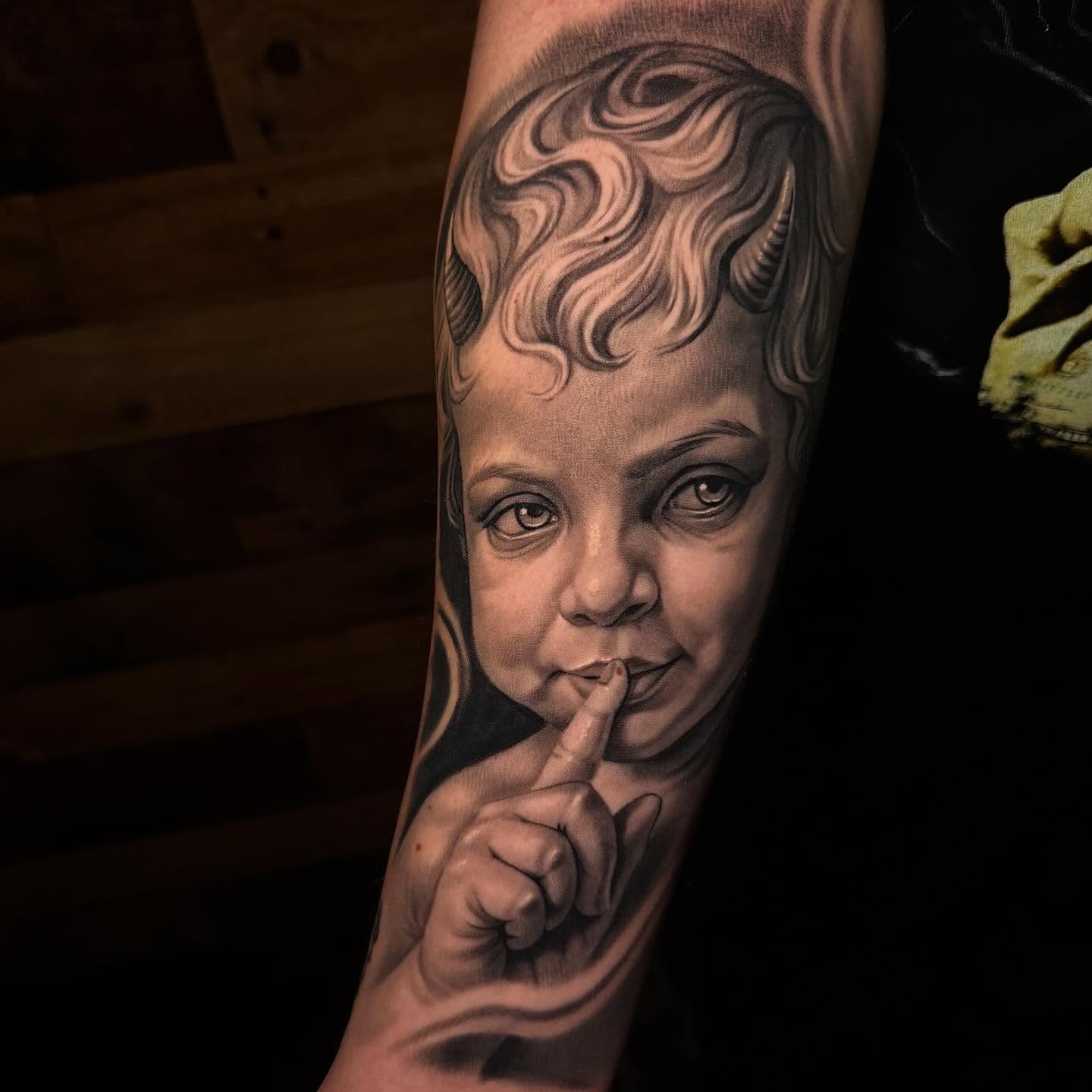Child's face realism tattoo on the forearm by Edgar Campaña