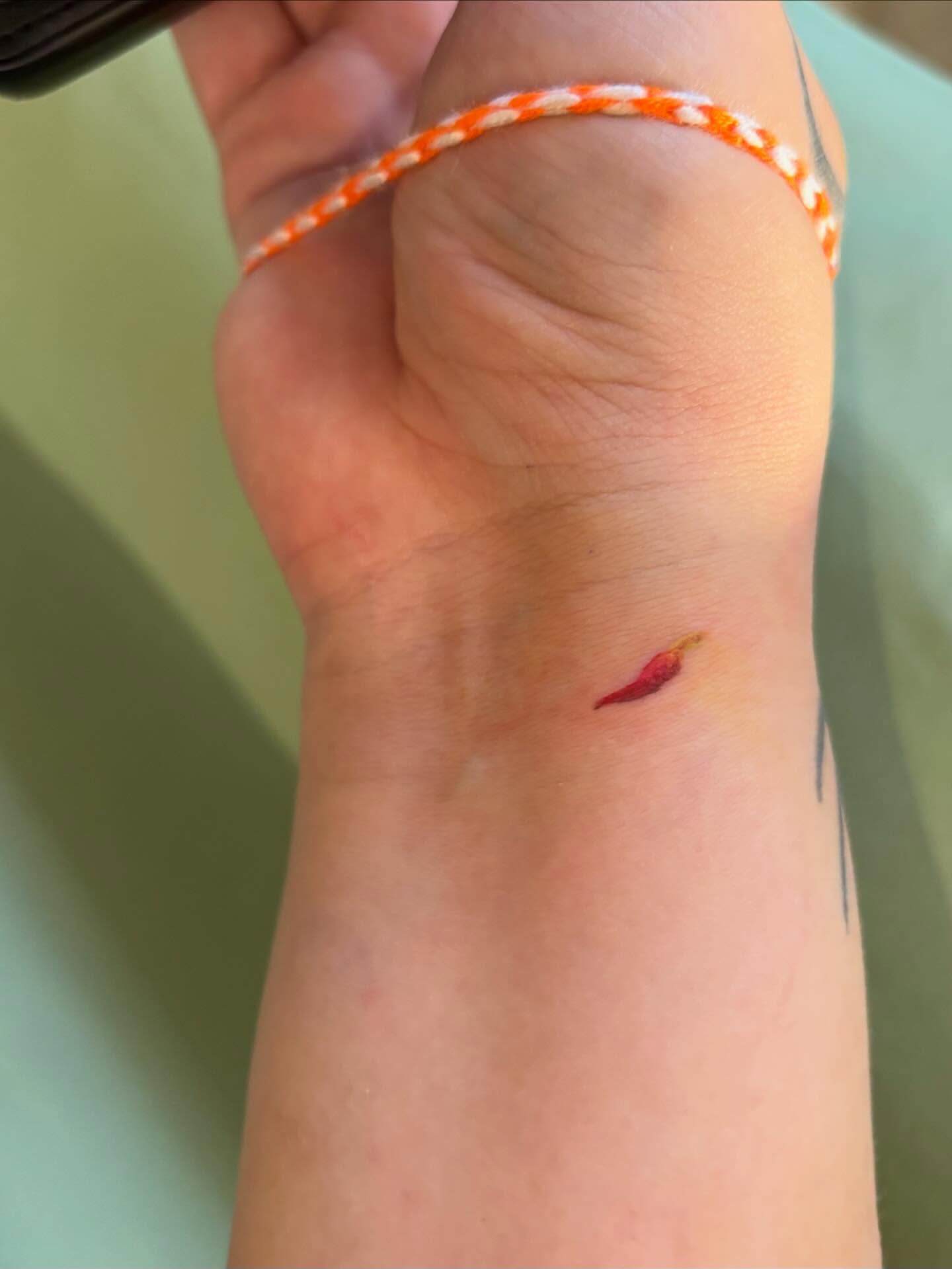 Chili pepper minimalist tattoo on the forearm by Runtz Tattoo, Greensboro, North Carolina