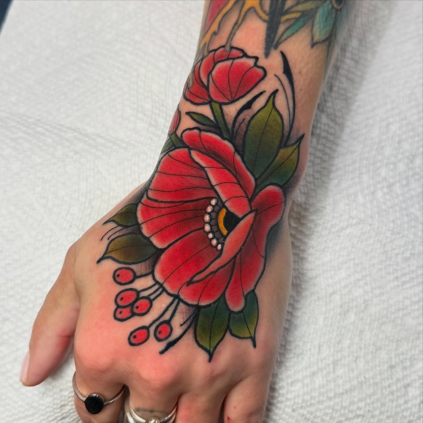 Red poppy American traditional tattoo on the hand by ๐ ๐ต๐๐๐๐๐ ๐ฎ๐๐๐๐๐๐๐๐๐