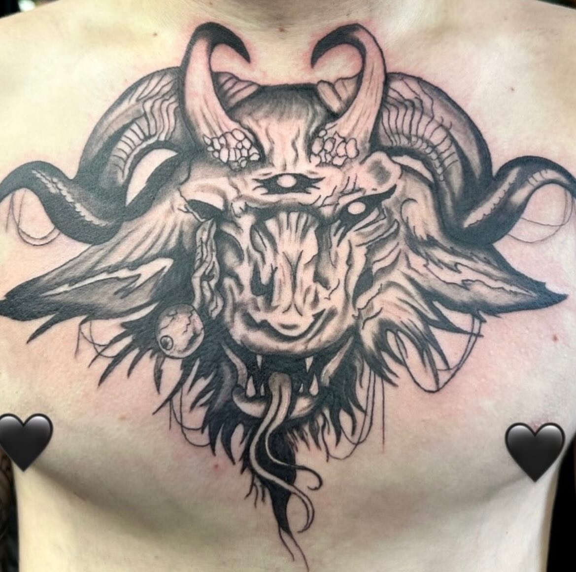 Demon head dark realism tattoo on the chest by Mika'la Berry