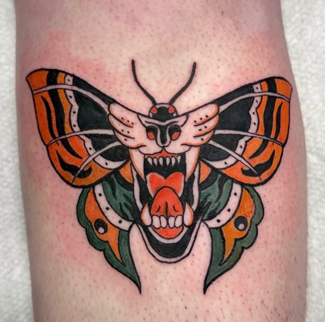 Butterfly American traditional tattoo on the thigh by Mika'la Berry