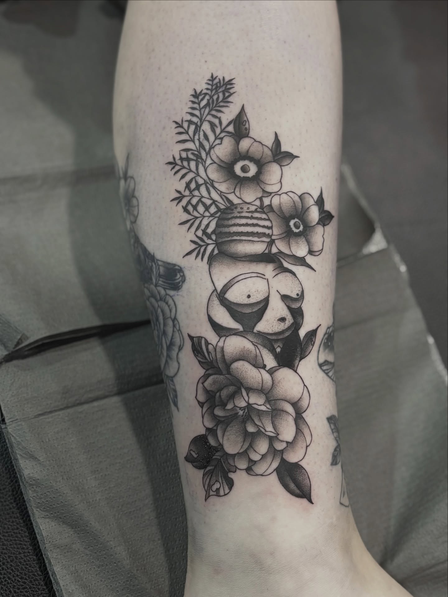 Abstract figure with flowers surrealism tattoo on the forearm by Elise Lamoureux- Tattoo Artist, Airdrie, Alberta