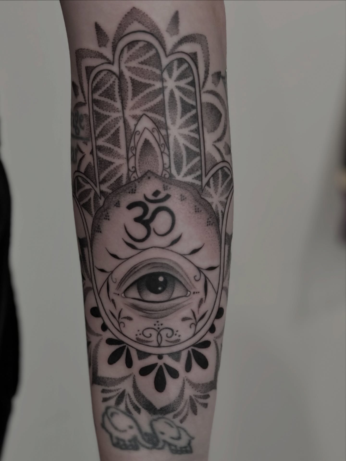 Eye with om symbol ornamental tattoo on the forearm by Elise Lamoureux- Tattoo Artist, Airdrie, Alberta
