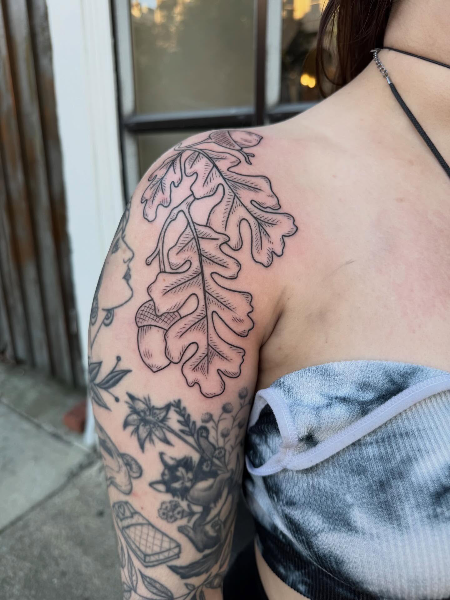Oak leaf black and grey tattoo on the shoulder by Maddie Hammell