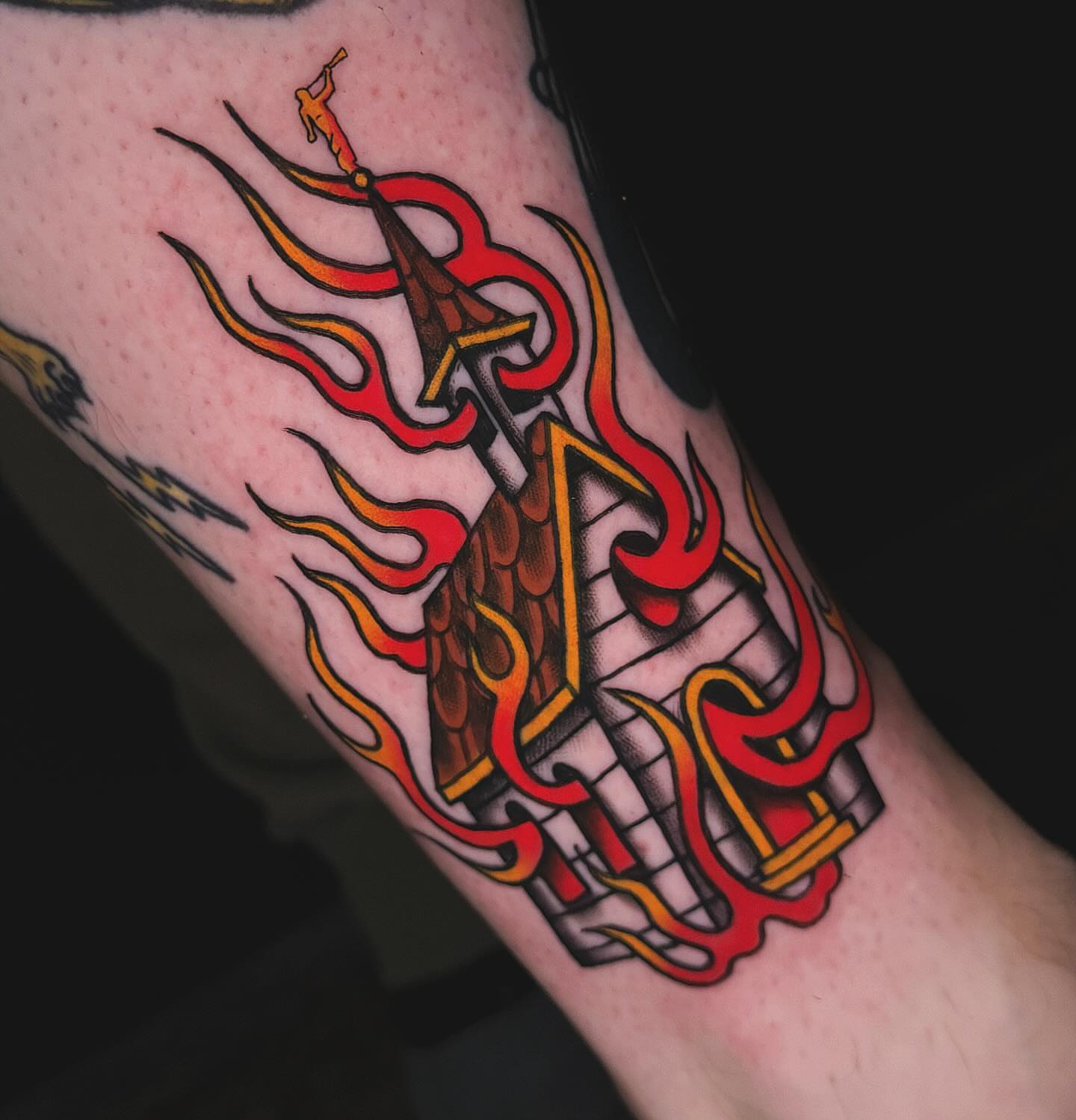 Castle on fire American traditional tattoo on the forearm by Nikki Bee