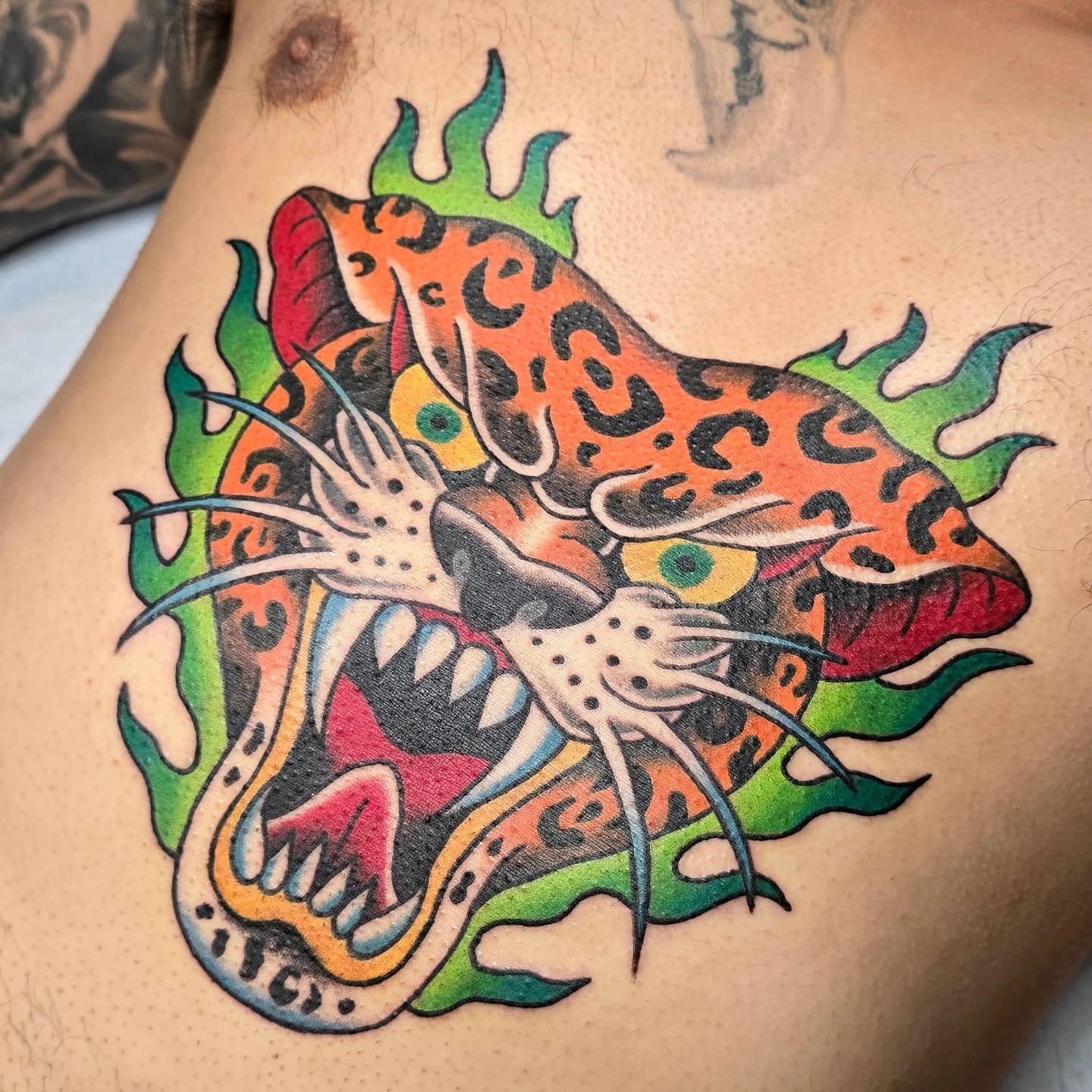 Jaguar American traditional tattoo on the chest by A. Teixeira, Los Angeles, California