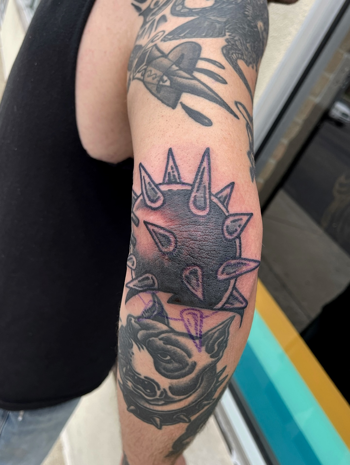 Spiked helmet black and grey tattoo on the forearm by Patrick Miller, Huber Heights, Ohio