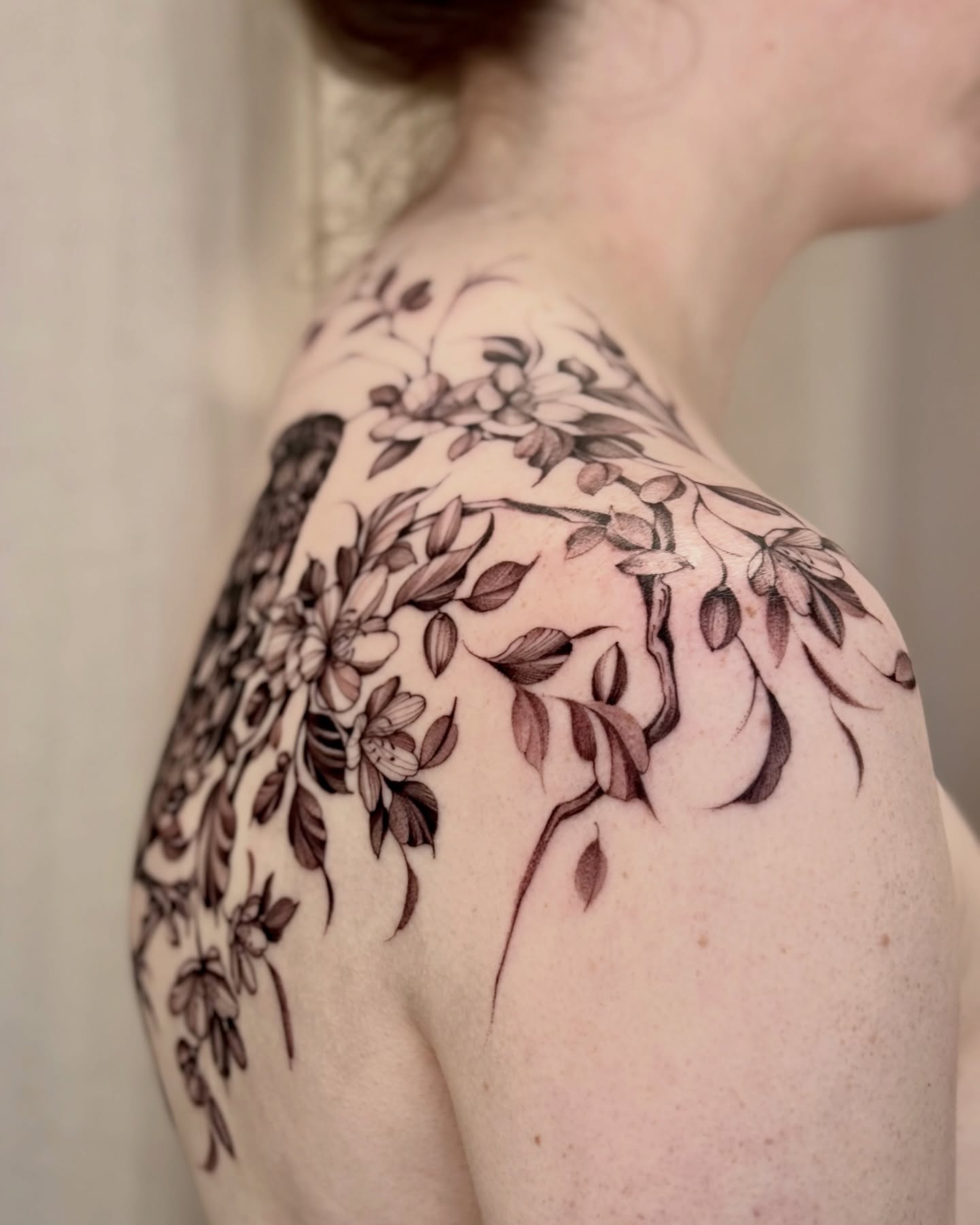 Floral vine black and grey tattoo on the shoulder by Dung Ngo