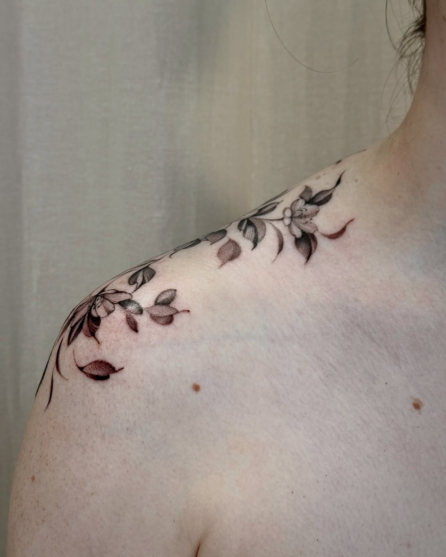 Floral design black and grey tattoo on the shoulder by Dung Ngo