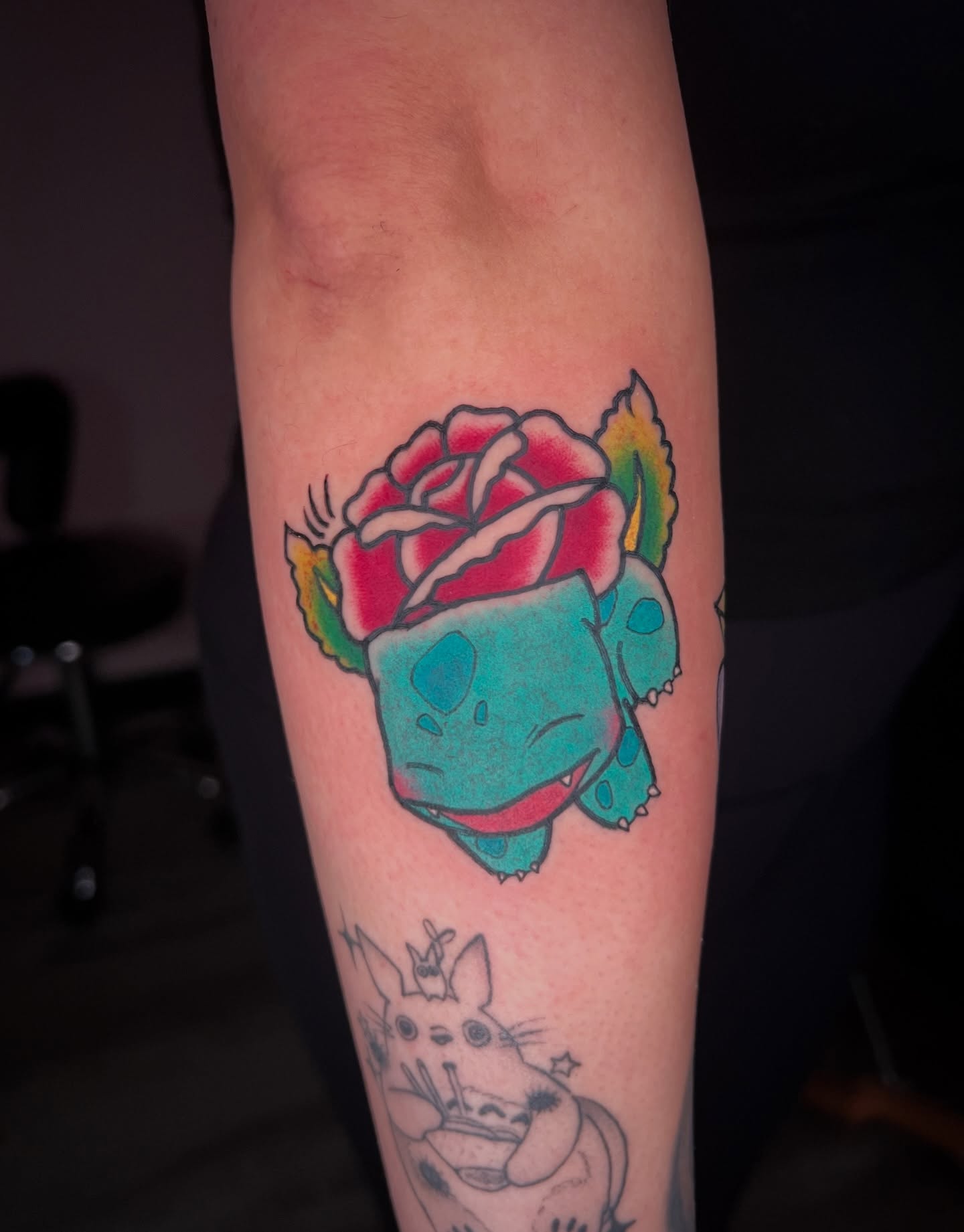 Bulbasaur with rose American traditional tattoo on the forearm by Chowdah Bowl