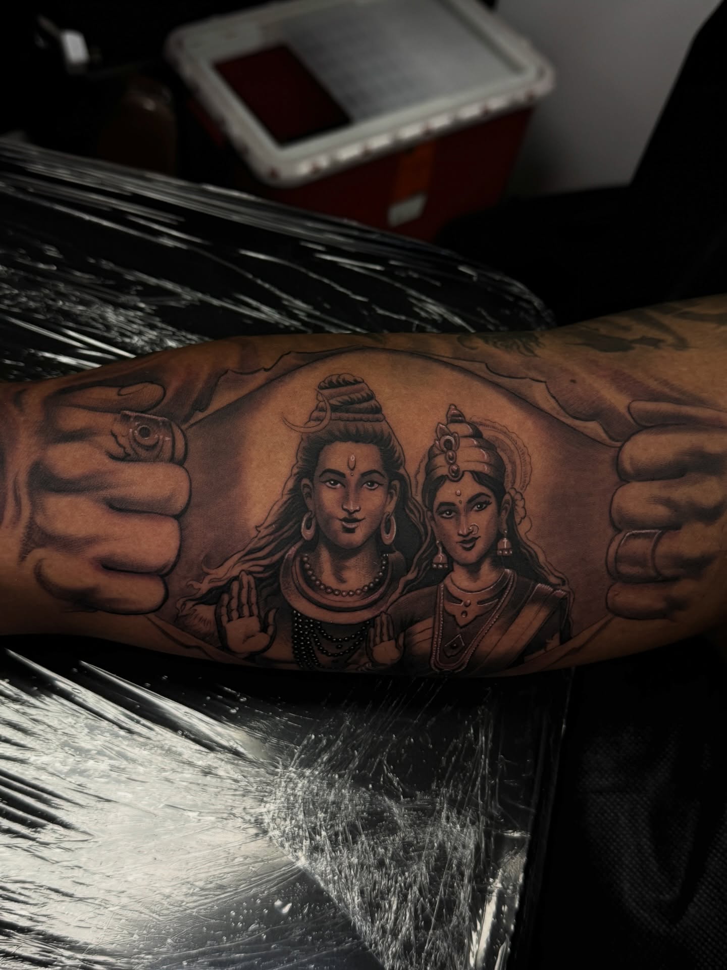 Shiva and Parvati black and grey tattoo on the forearm by TATTOOS by Elvis Ramos - California tattoo