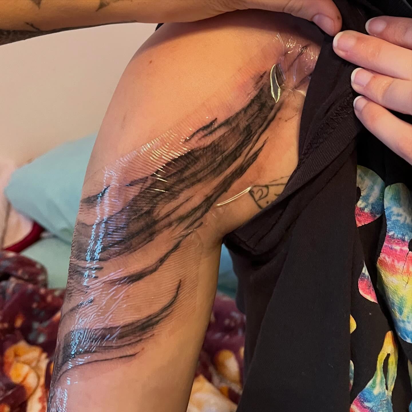 Abstract brushstrokes black and grey tattoo on the upper arm by ren