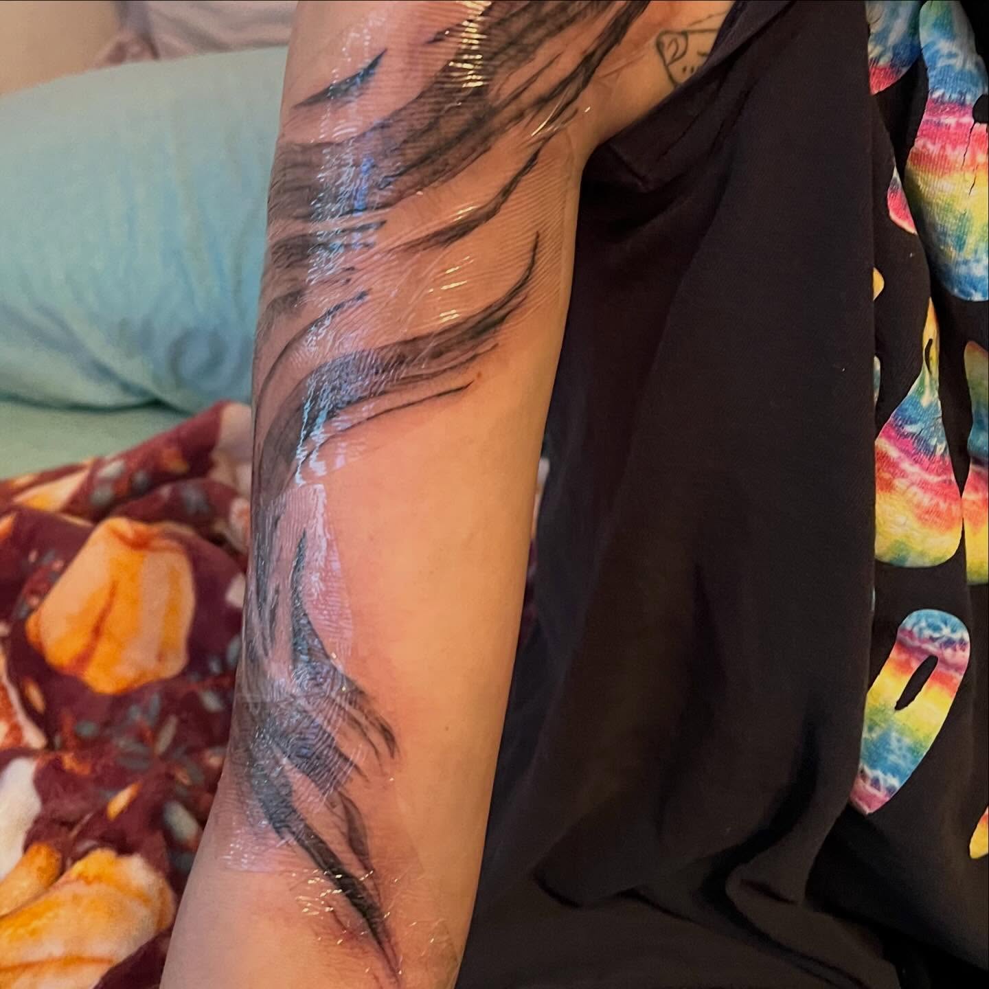 Abstract feather black and grey tattoo on the forearm by ren