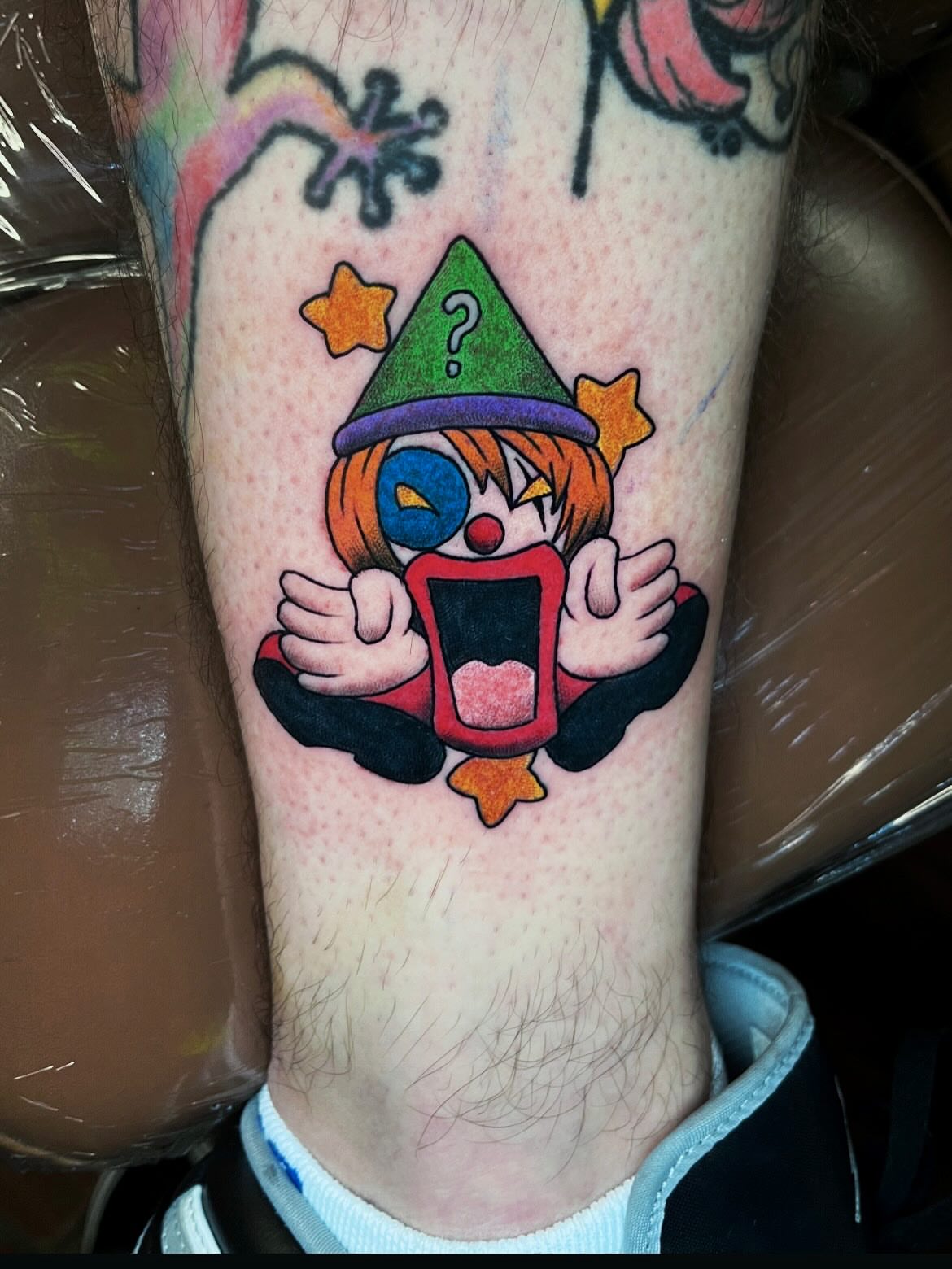 Clown reading book anime tattoo on the forearm by Nick Andrade Las Vegas Tattoo Artist