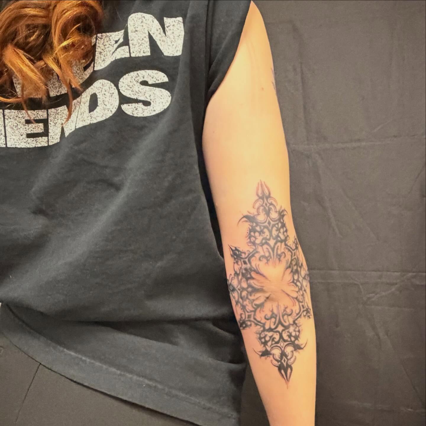 Floral pattern black and grey tattoo on the forearm by cortez