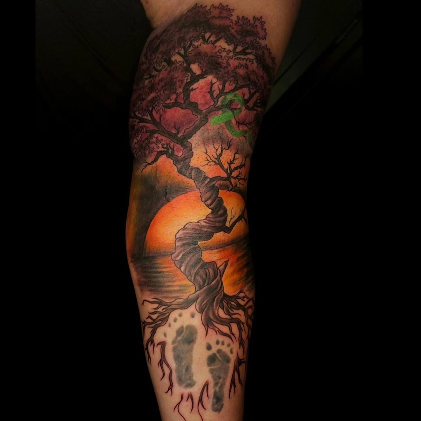 Tree and sunset realism tattoo on the forearm by Ian Duncanson