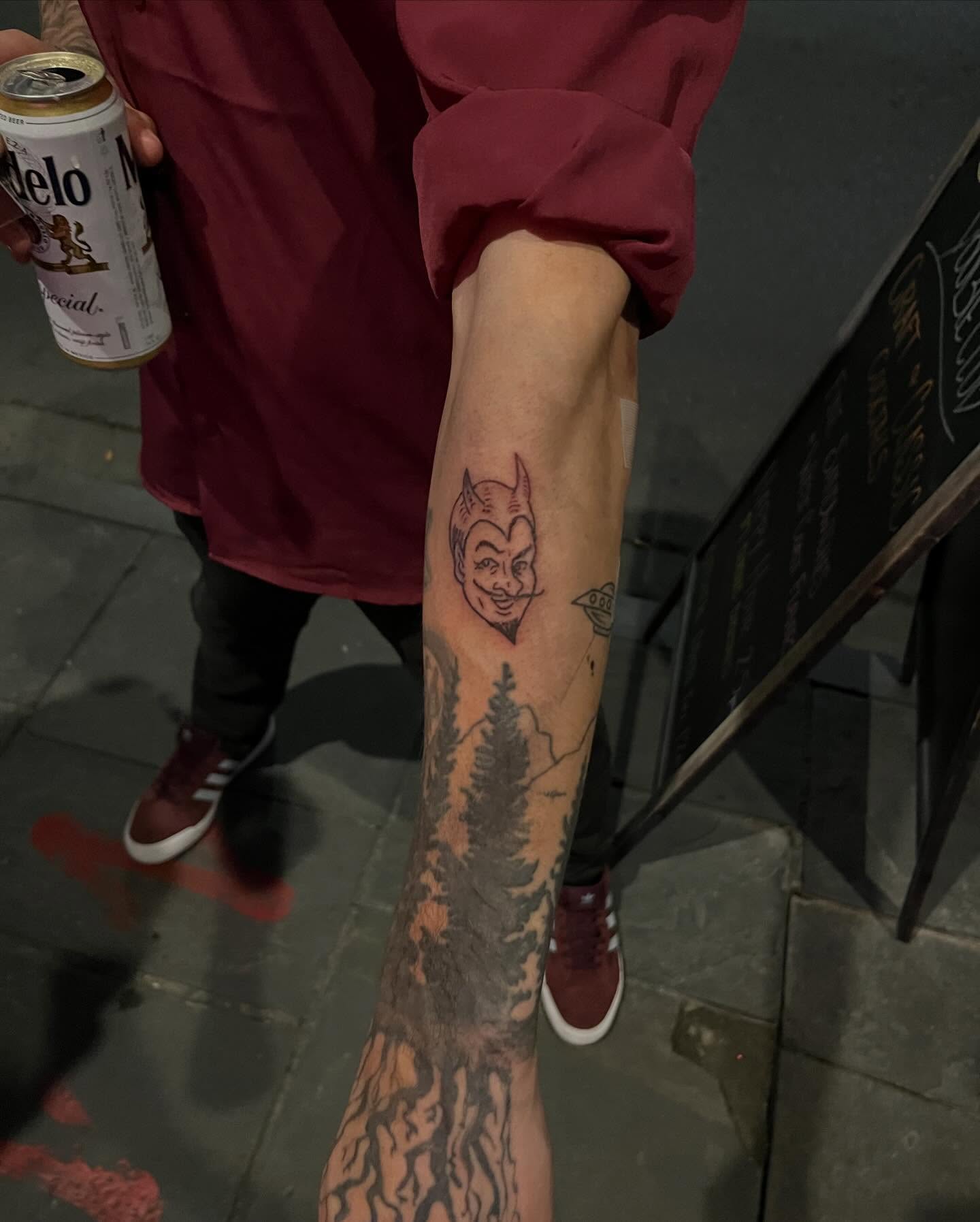 Devil face American traditional tattoo on the forearm by Rafaela Lopez