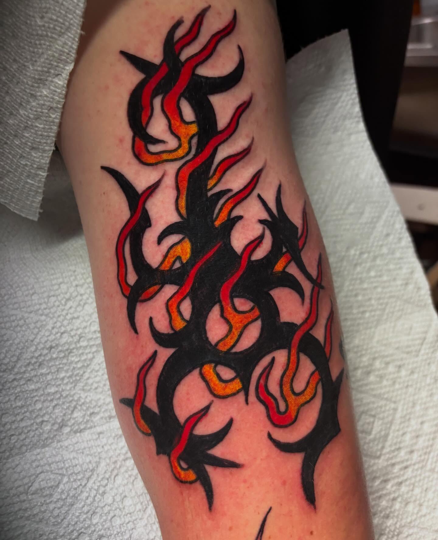 Flames neo-traditional tattoo on the forearm by Chris Dufresne