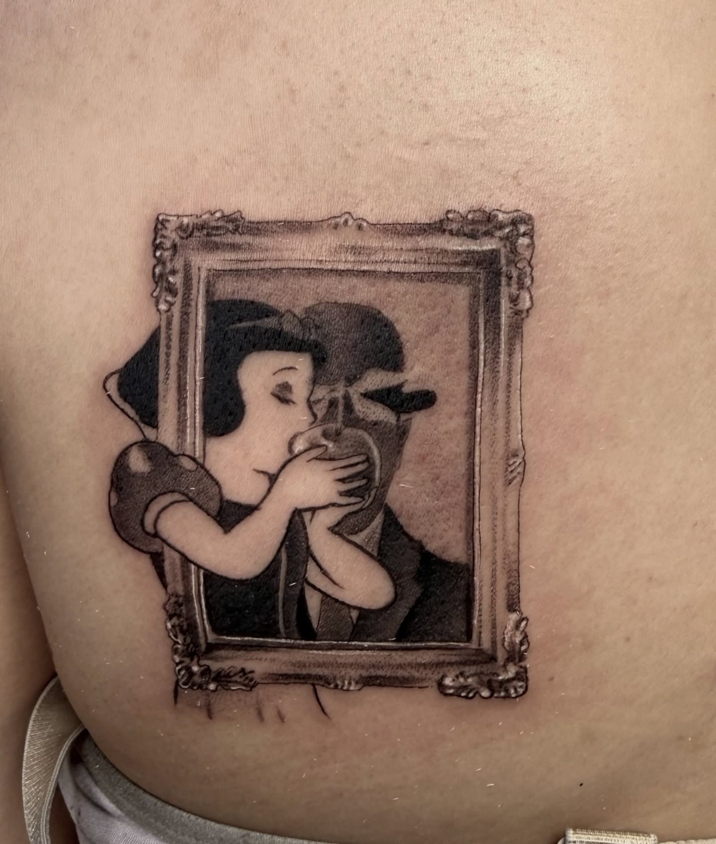 Kissing couple black and grey tattoo on the back by Abrianna