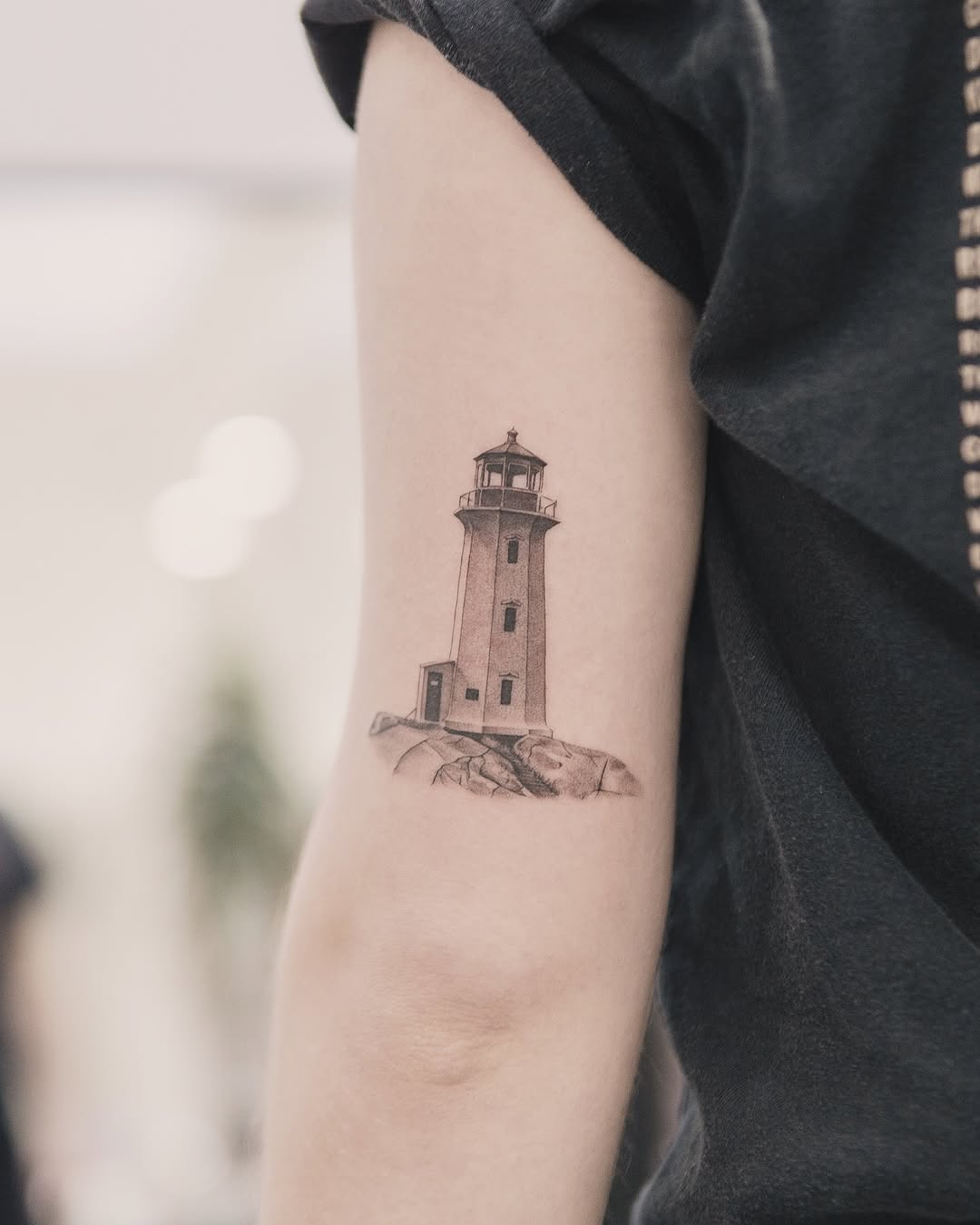 Lighthouse on rocks minimalist tattoo on the forearm by Joey