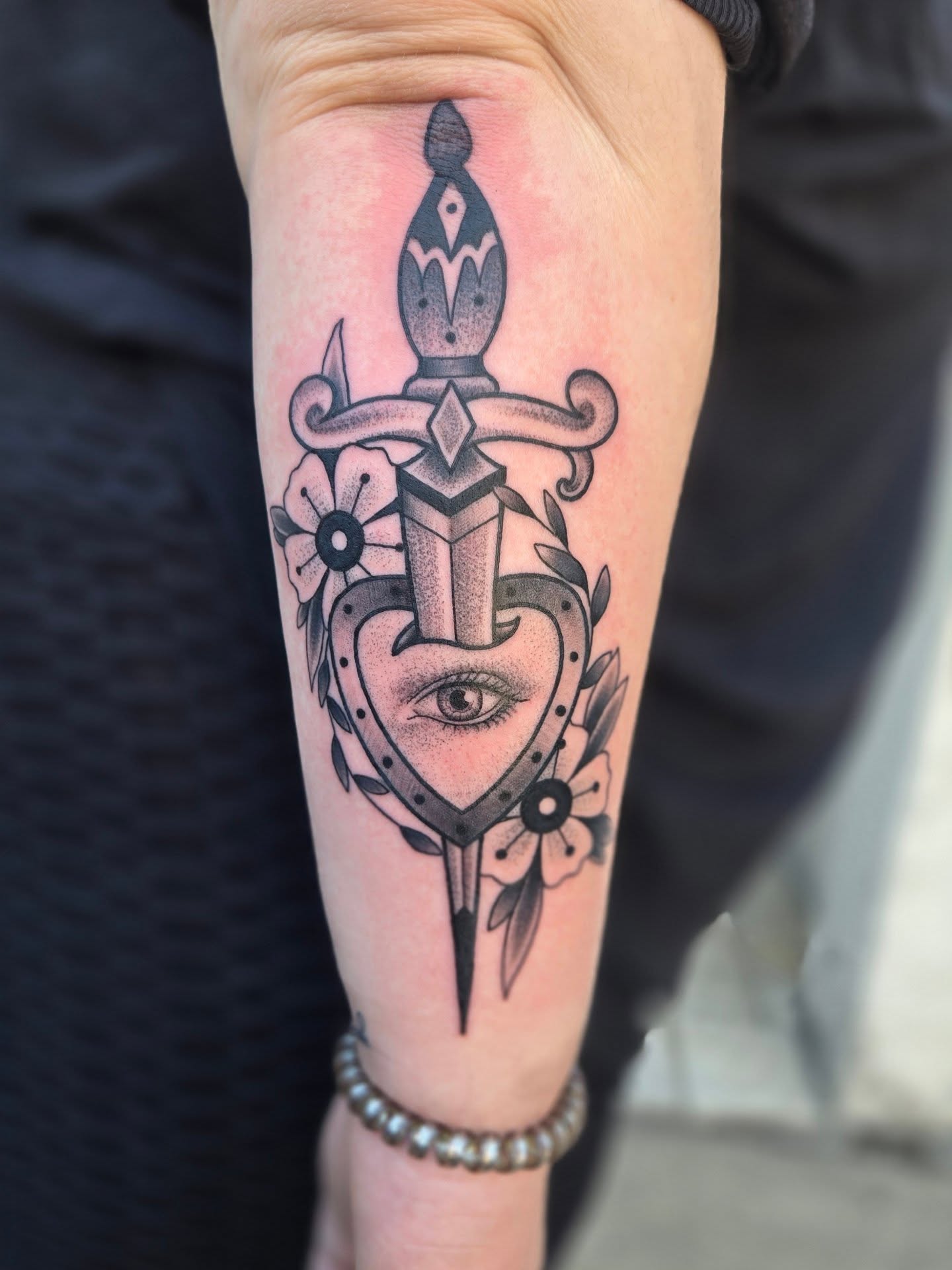 Heart with dagger American traditional tattoo on the forearm by Angel O'Connor Tattoos