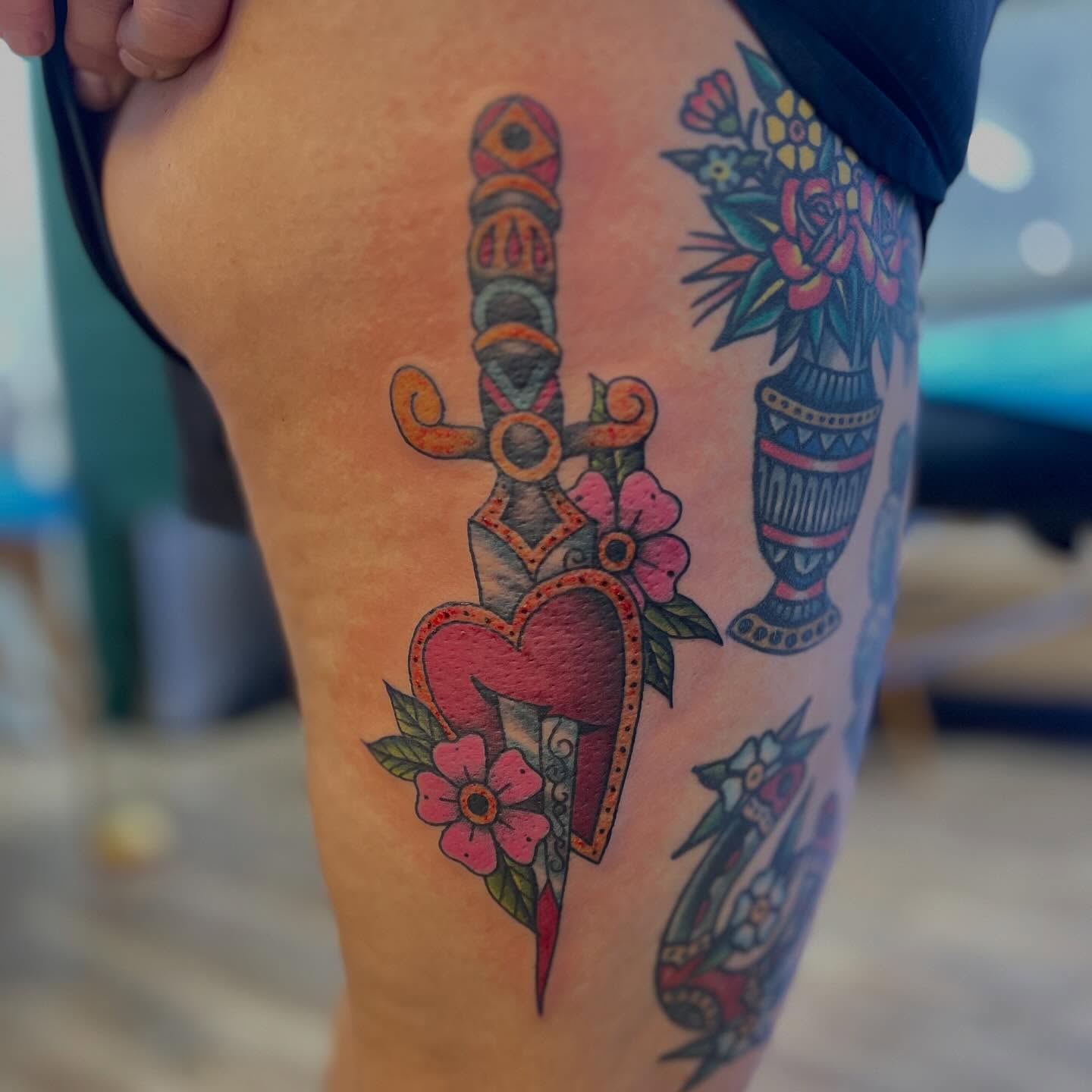 Heart pierced by dagger American traditional tattoo on the thigh by Victorian Coleman