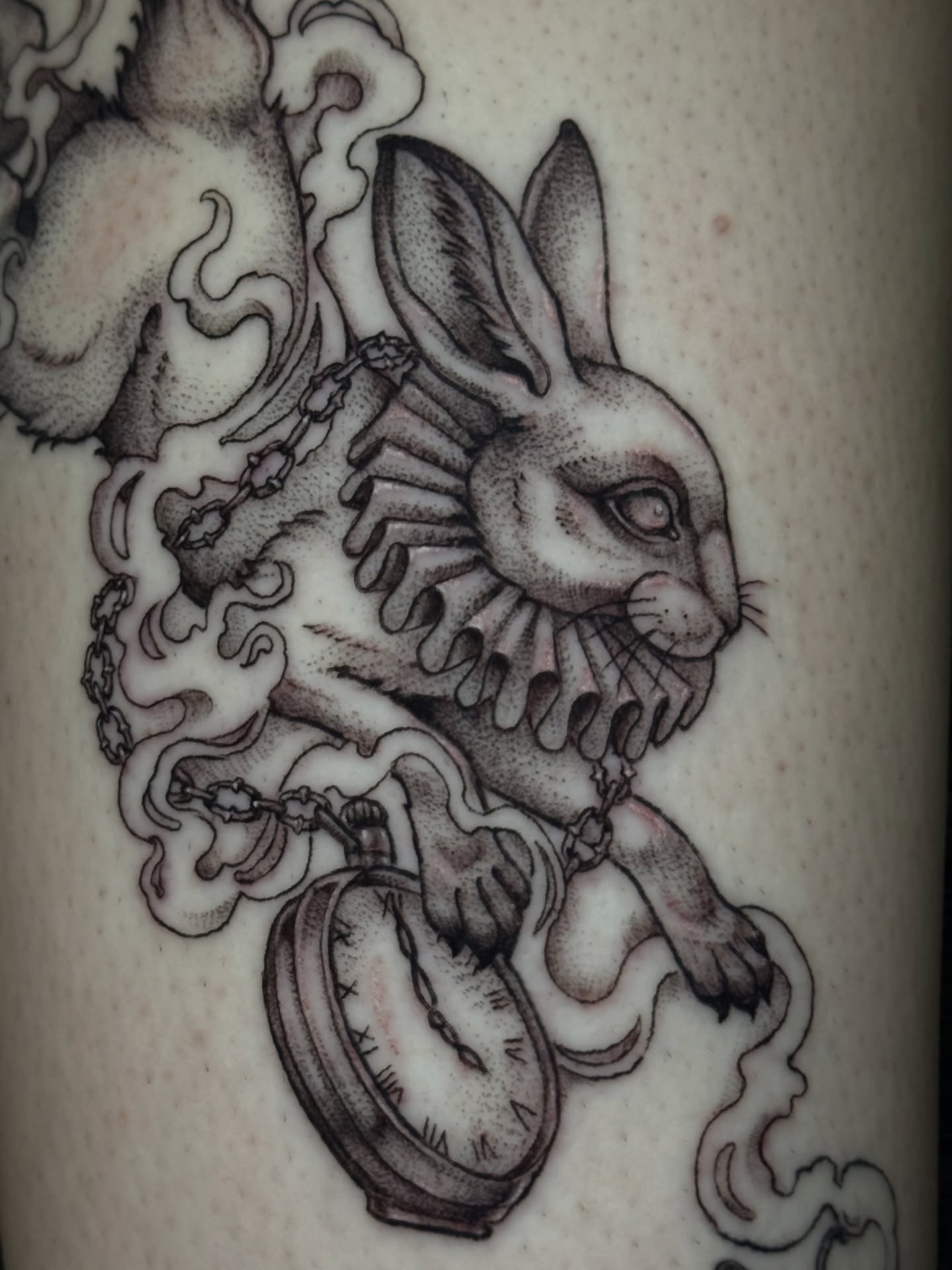 Rabbit with pocket watch surrealism tattoo on the forearm by Cristen Aro