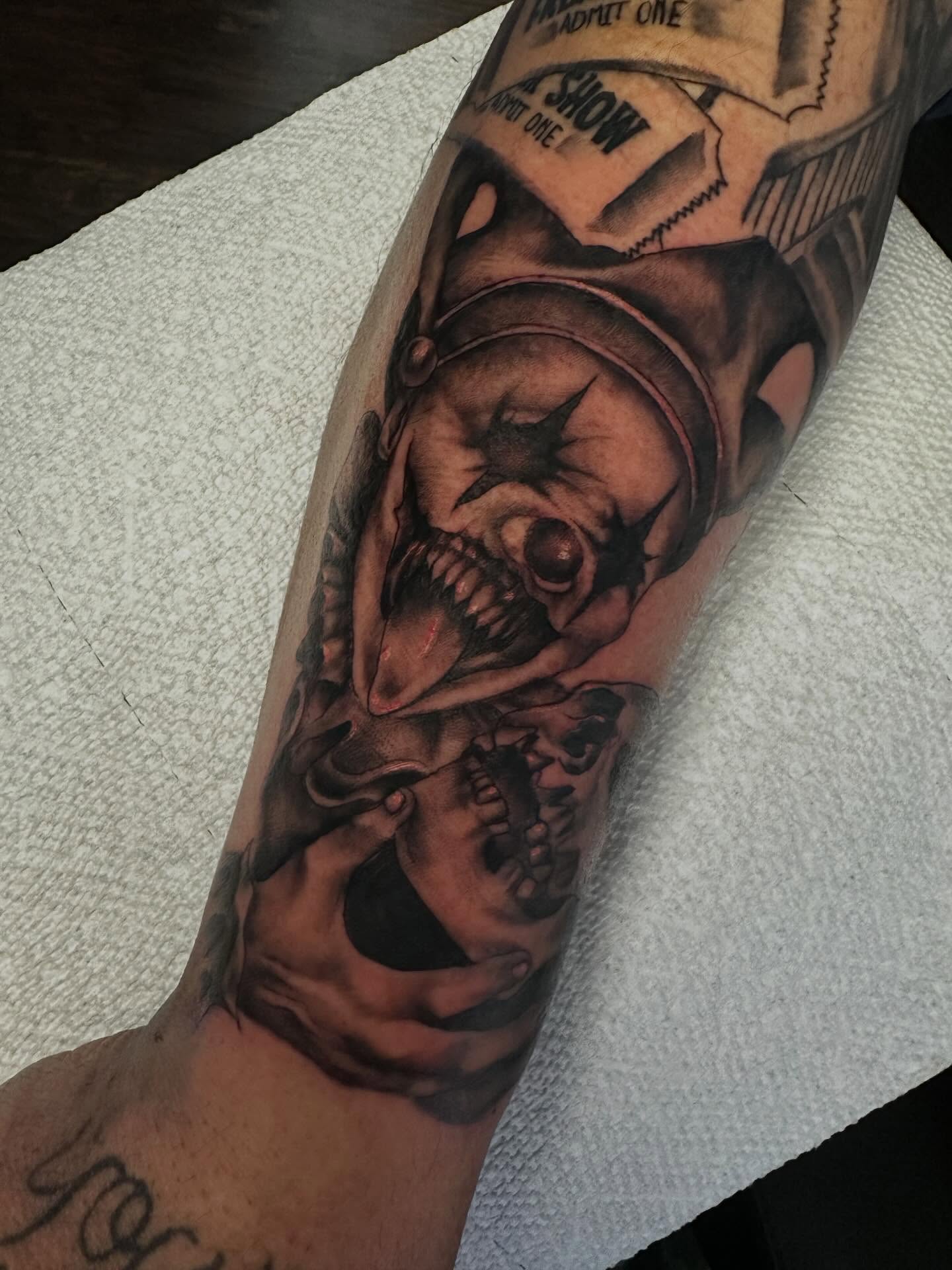 Clown dark realism tattoo on the forearm by Elisha B🦷