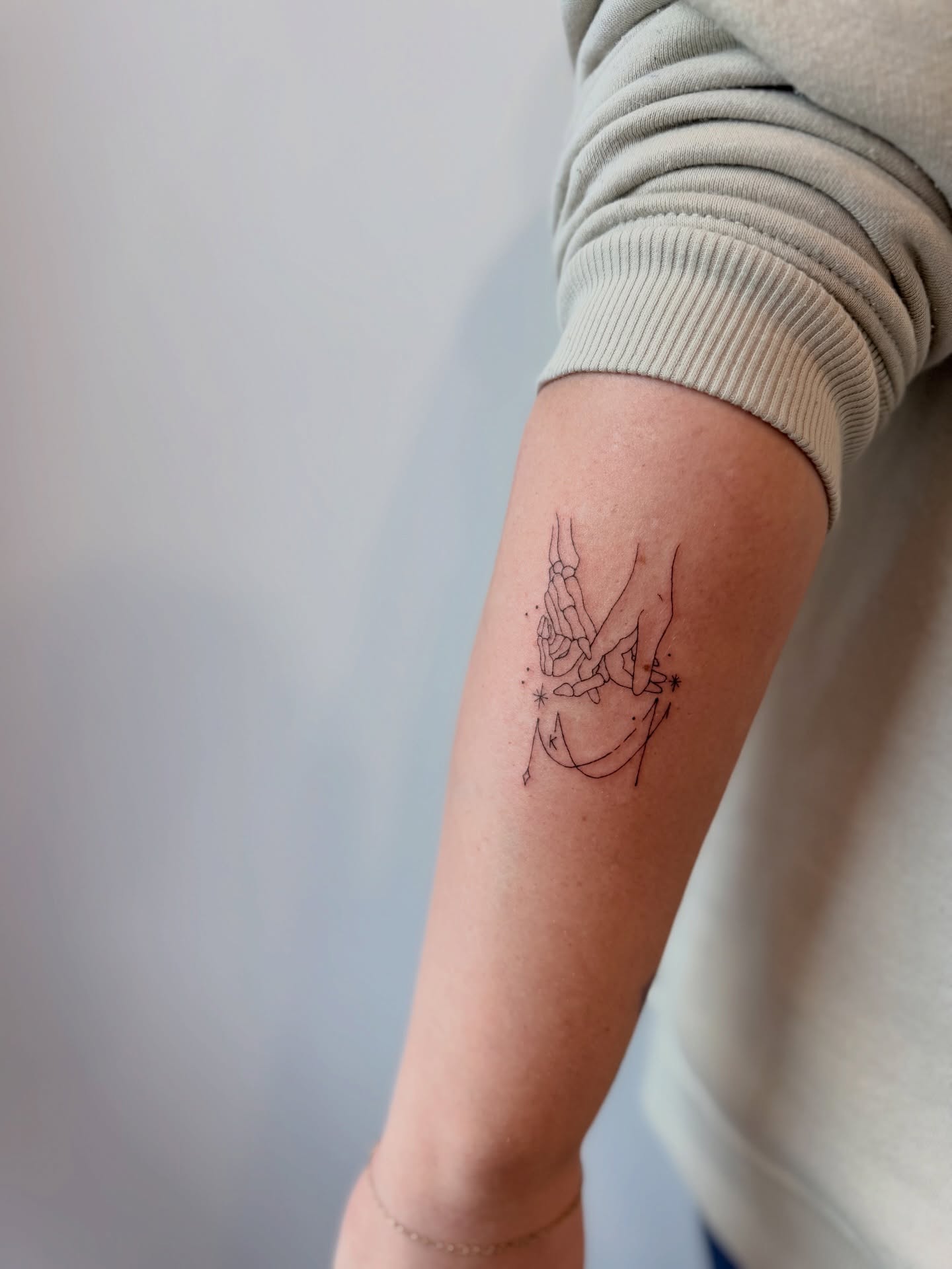 Astronaut minimalist tattoo on the forearm by Reverie Studio
