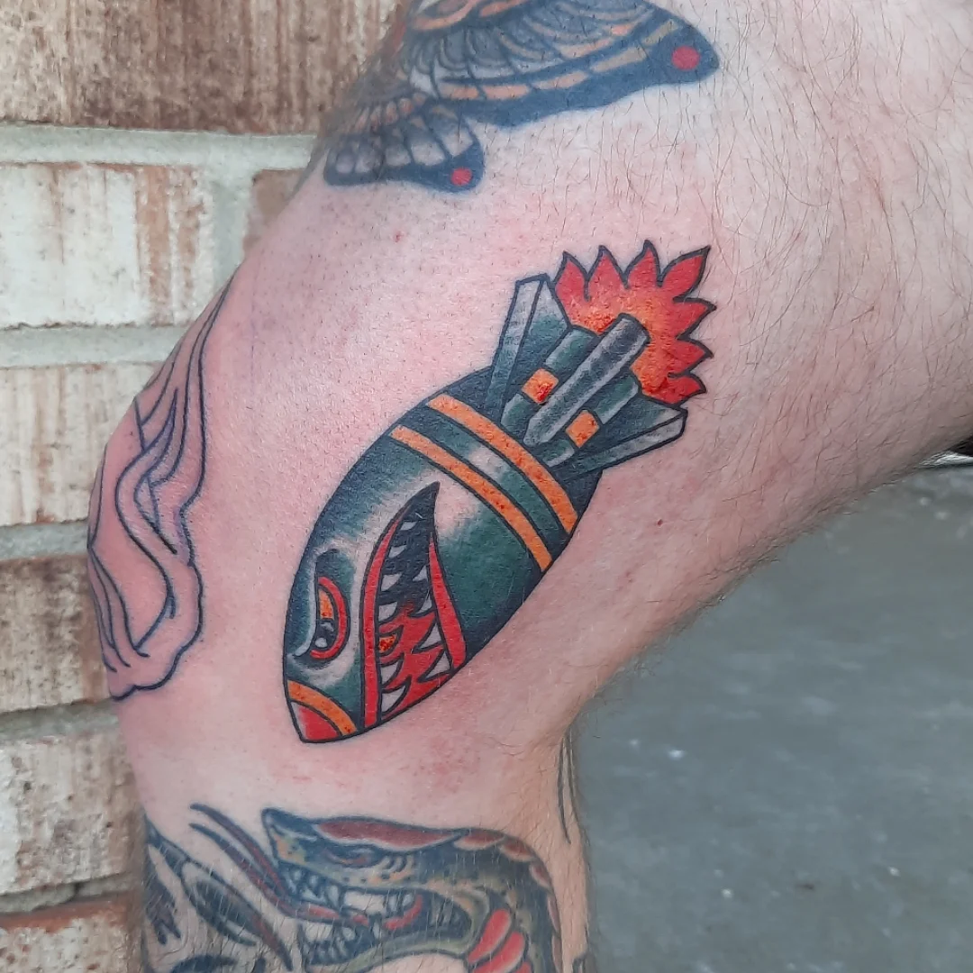 Fish and dynamite American traditional tattoo on the forearm by Kaetlyn