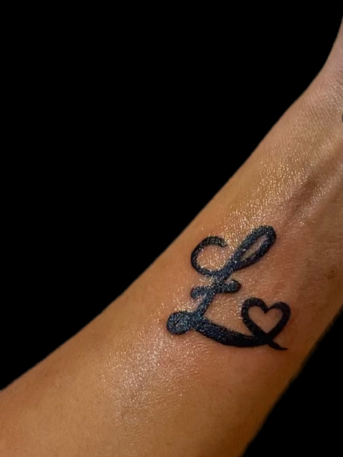 Script letter L with heart lettering script tattoo on the forearm by 𝒯𝒶𝓉𝓈𝑜𝓊𝓁 𝒷𝓎 C𝓁𝒶𝓊𝒹𝒾𝒶