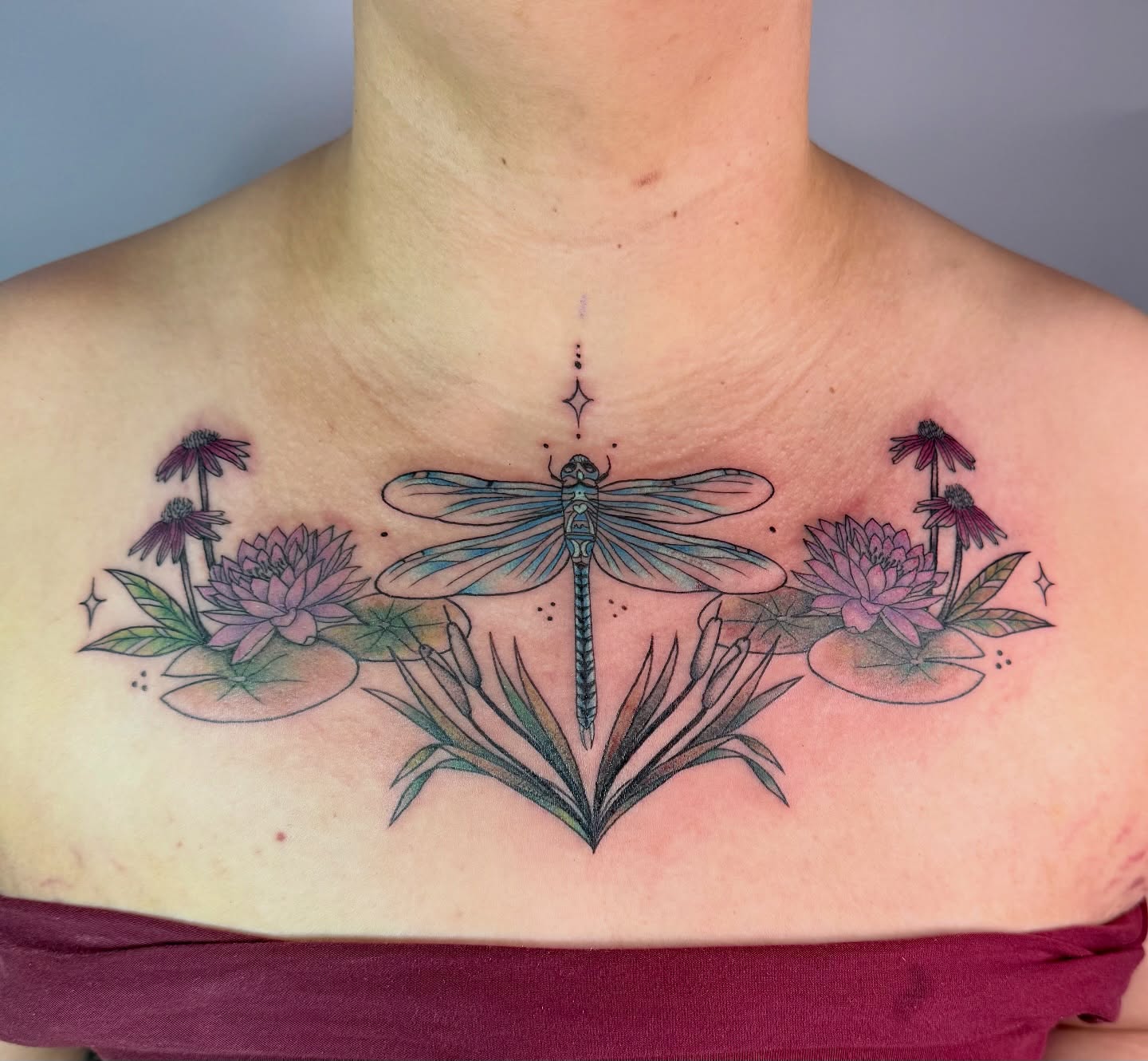 Dragonfly and flowers dotwork tattoo on the chest by Jenna Nicole