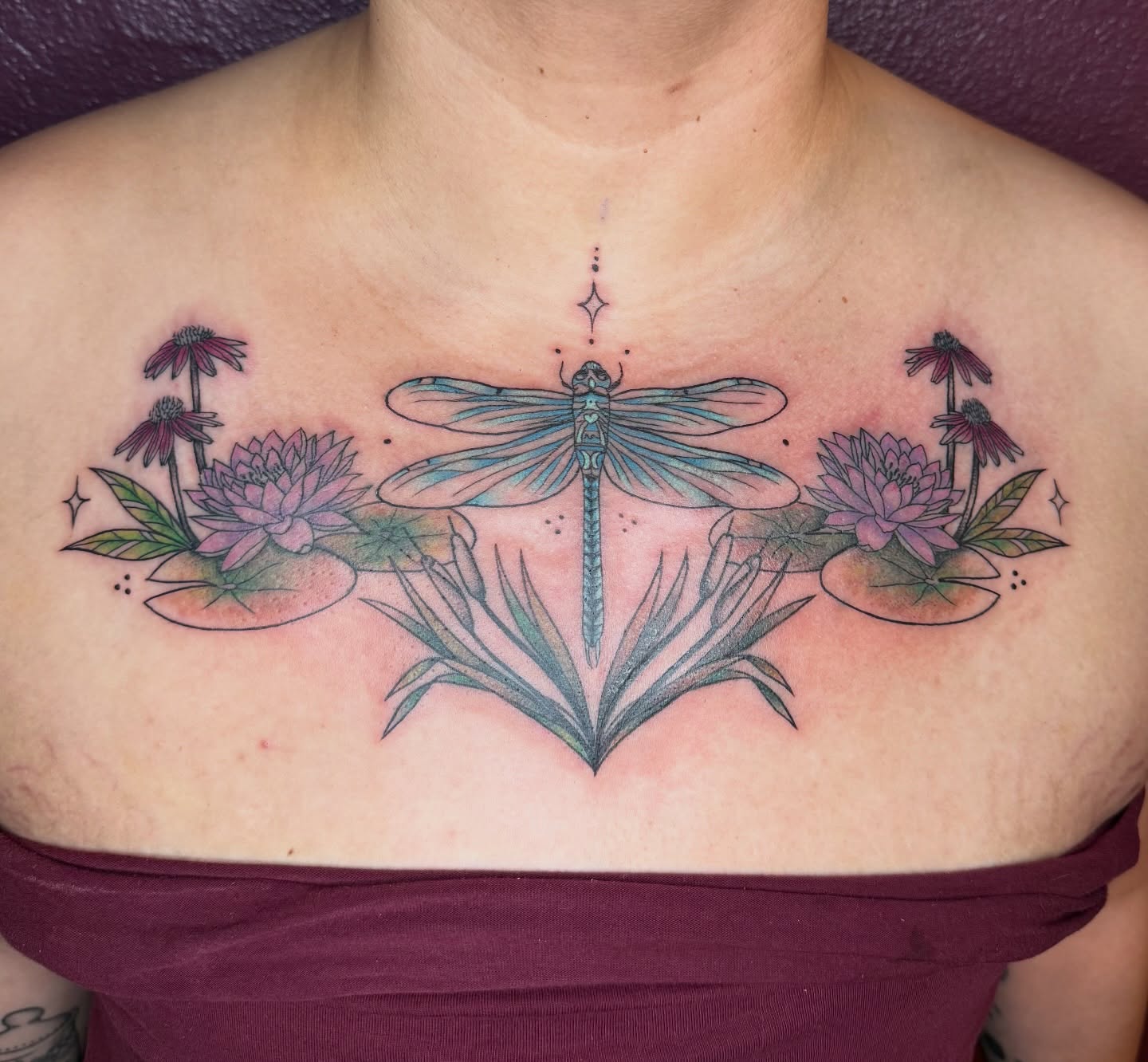 Dragonfly and flowers dotwork tattoo on the chest by Jenna Nicole